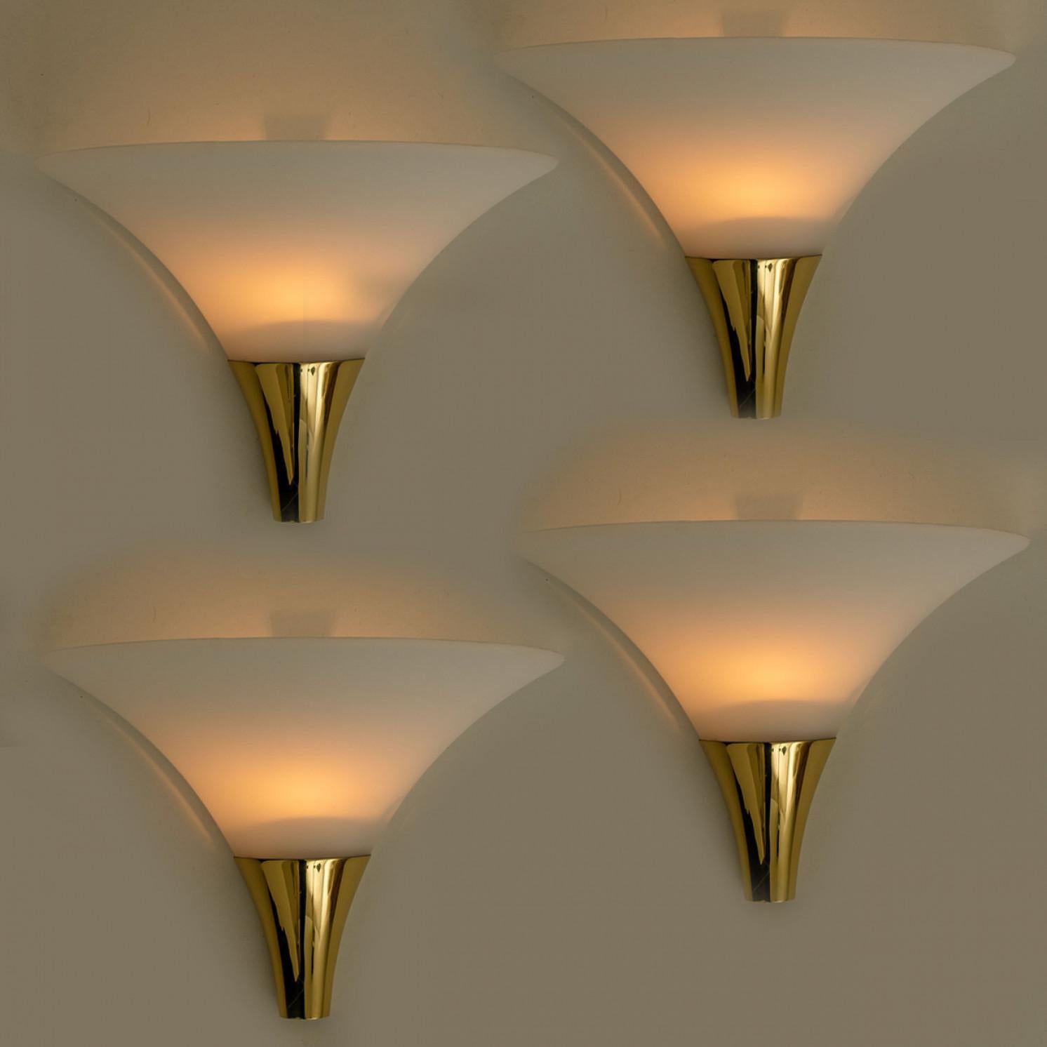 1 of the 16 Opaque Glass / Brass Wall Lights by Limburg, 1970s In Good Condition For Sale In Rijssen, NL