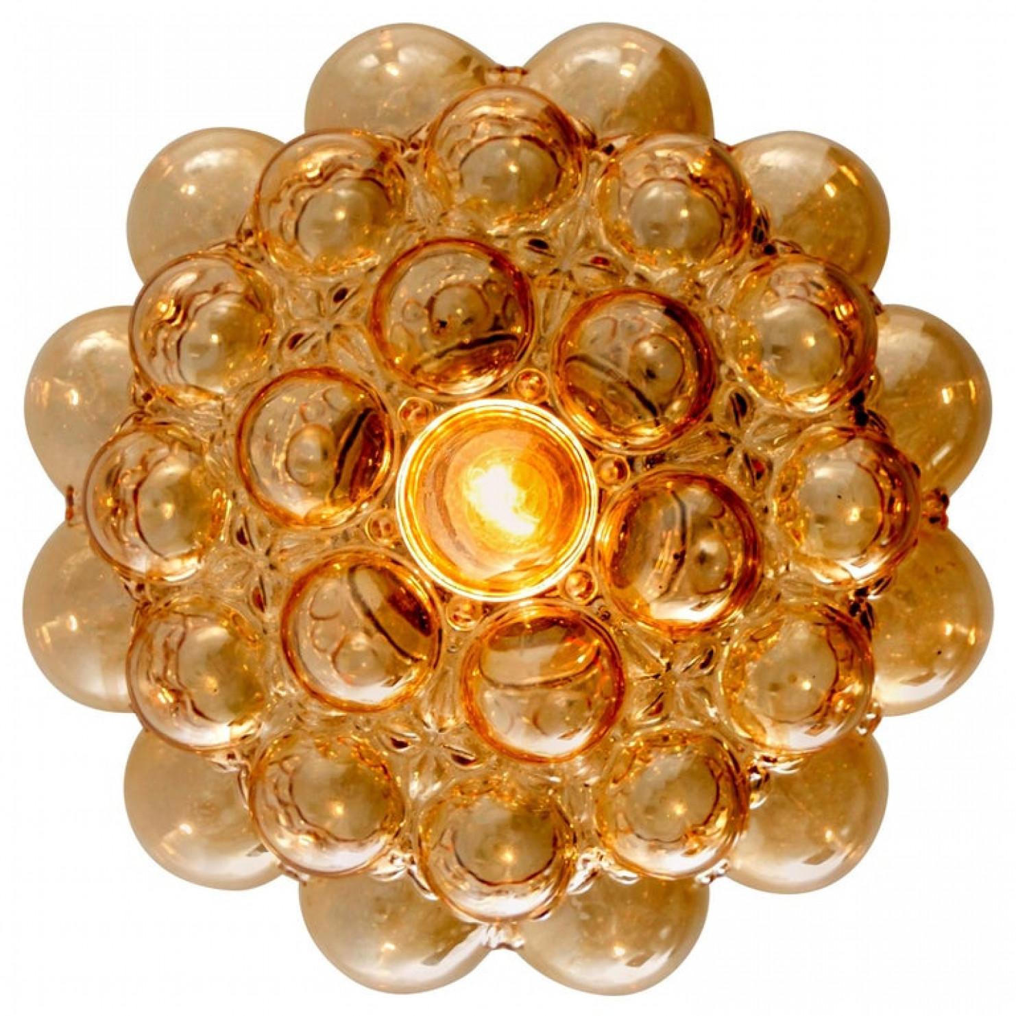 1 of the 2 beautiful bubble glass light fixtures designed by Helena Tynell for Glashütte Limburg. Design Classics, the hand blown glass gives a wonderful warm glow. Illuminates beautifully on the wall and ceiling.

Dimensions wall lights:
Height