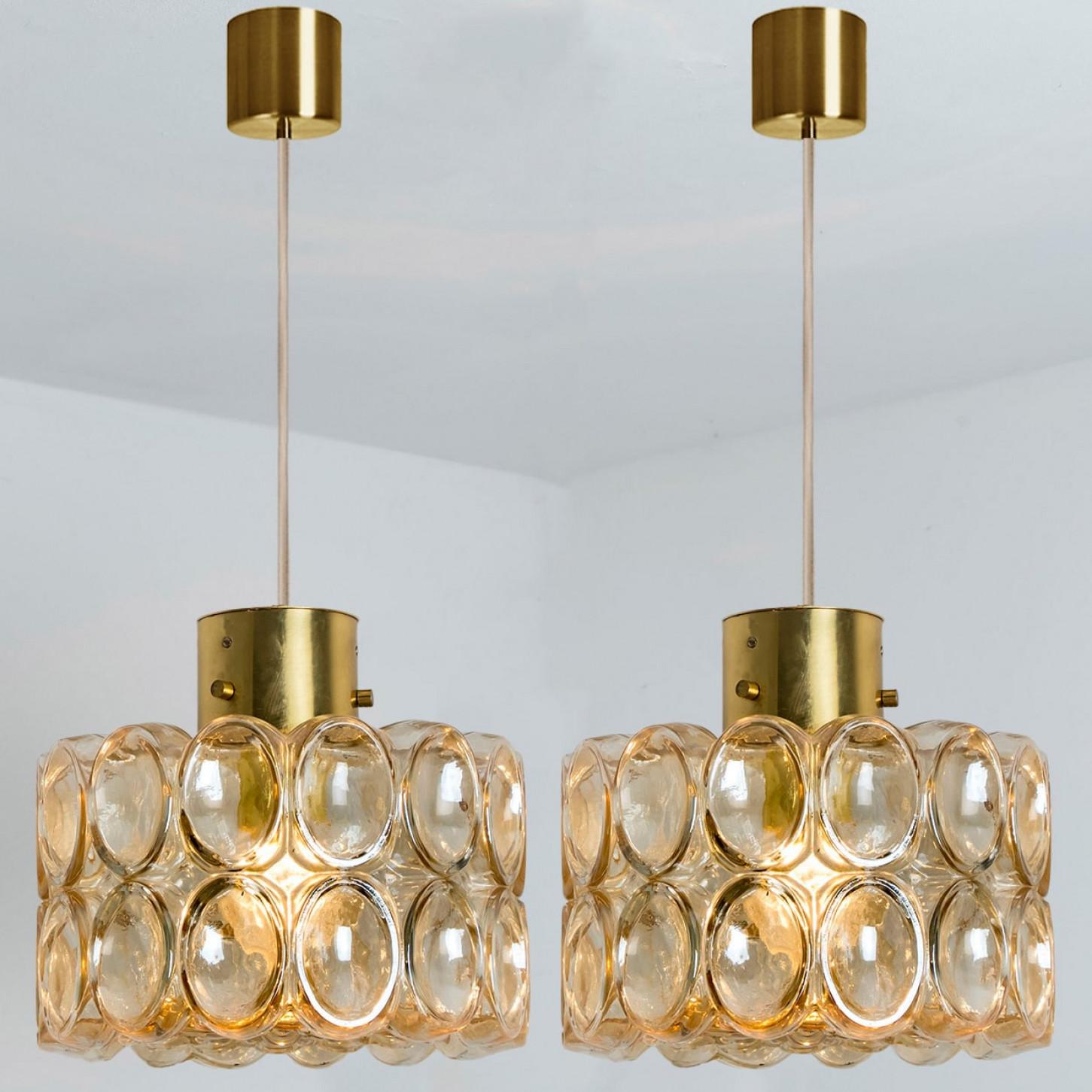 Several beautiful bubble glass pendant lights designed by Helena Tynell for Glashütte Limburg, 1960. A classig design with chrome colored details, the hand blown amber glass gives a wonderful glow.

Helena Tynell is a finish glass and ceramics