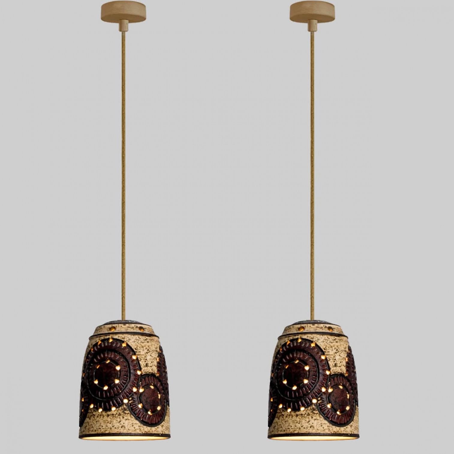 Stylish ceramic pendant lights made in Denmark. The lamp is made of beige and burgundy colorred ceramics and has a pattern with circles with holes on it. Illuminates beautifully.

A unique statement piece in the room.

Cleaned, well-wired, in full