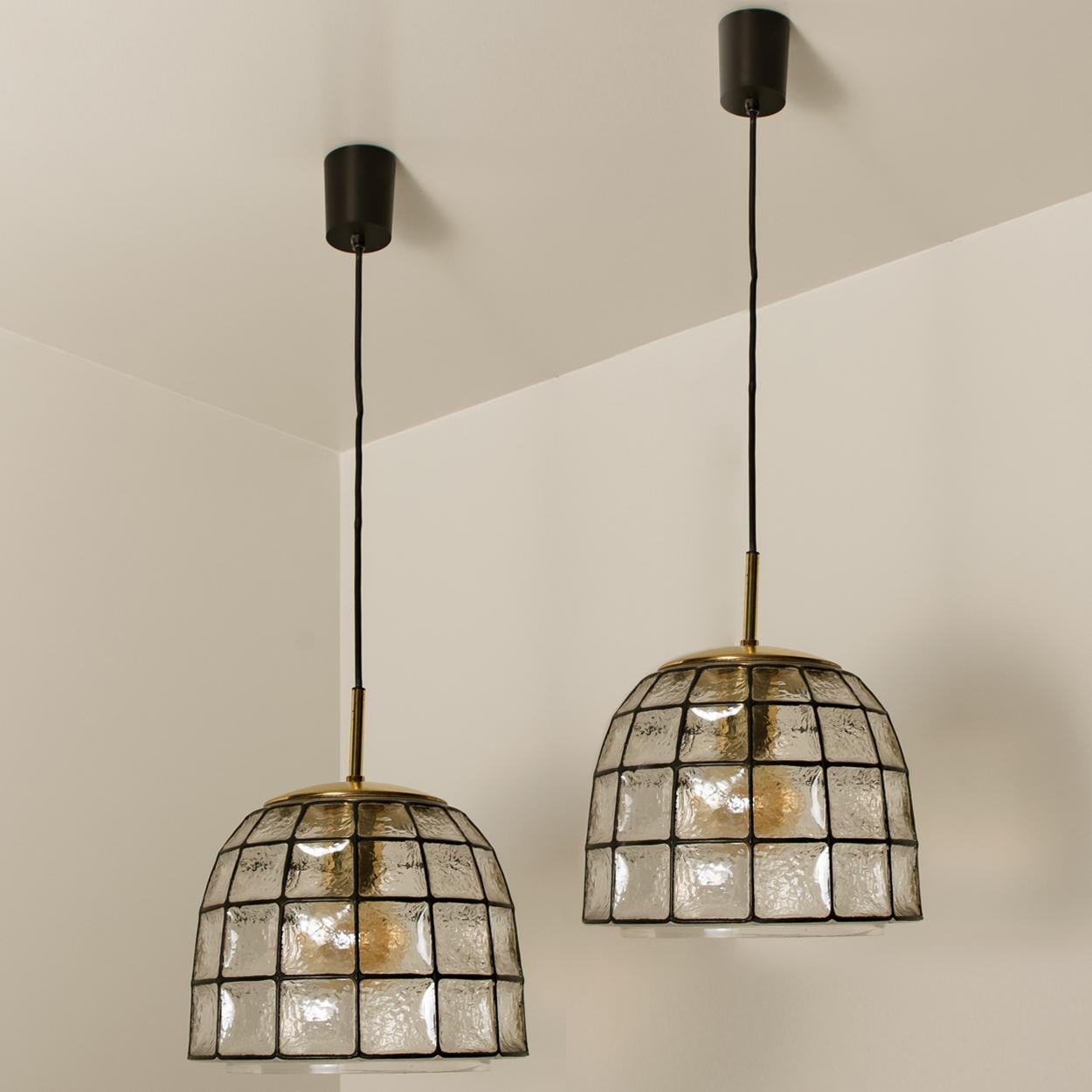 Minimal, geometric and simply shaped design. This beautiful and unique pair of hand blown glass chandeliers or pedant lights were manufactured by Glashütte Limburg in Germany during the 1960s, (late 1960s or early 1970s). Beautiful craftsmanship.