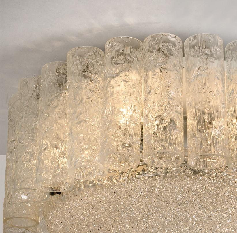 Two large Doria flush mount chandeliers, organic glass tubes surrounding a central glass diffuser mounted with minimal exposed hardware for a clean and elegant look. The stylish elegance of this lamp suits many environment, from midcentury to