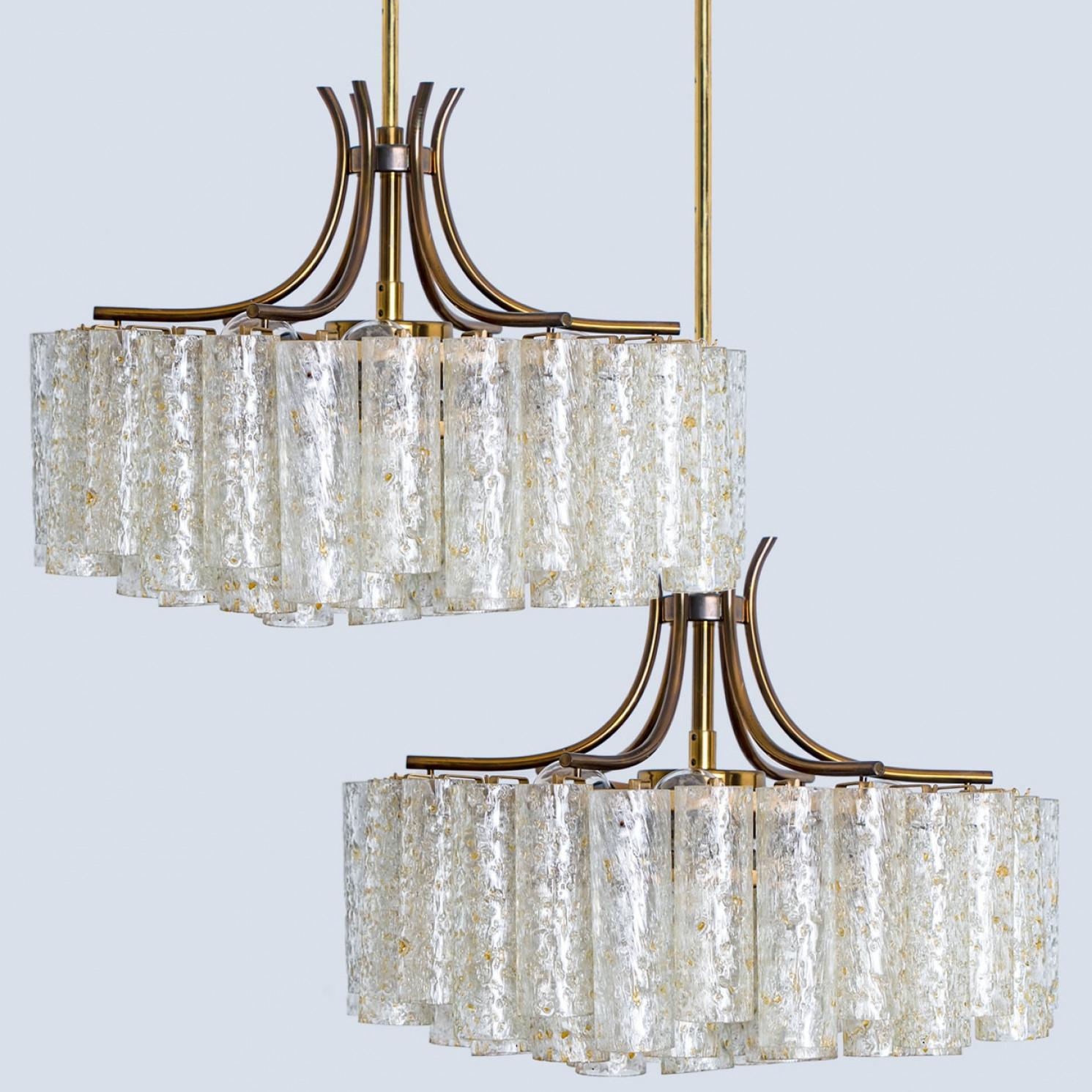 Mid-century modern chandelier produced by Doria Leuchten in Germany in the 1960s. The lamp features a brass frame with 50 Murano glass tubes with gold flakes hanging from it.

The chandelier has seven E14 sockets.

Cleaned, well-wired and ready to