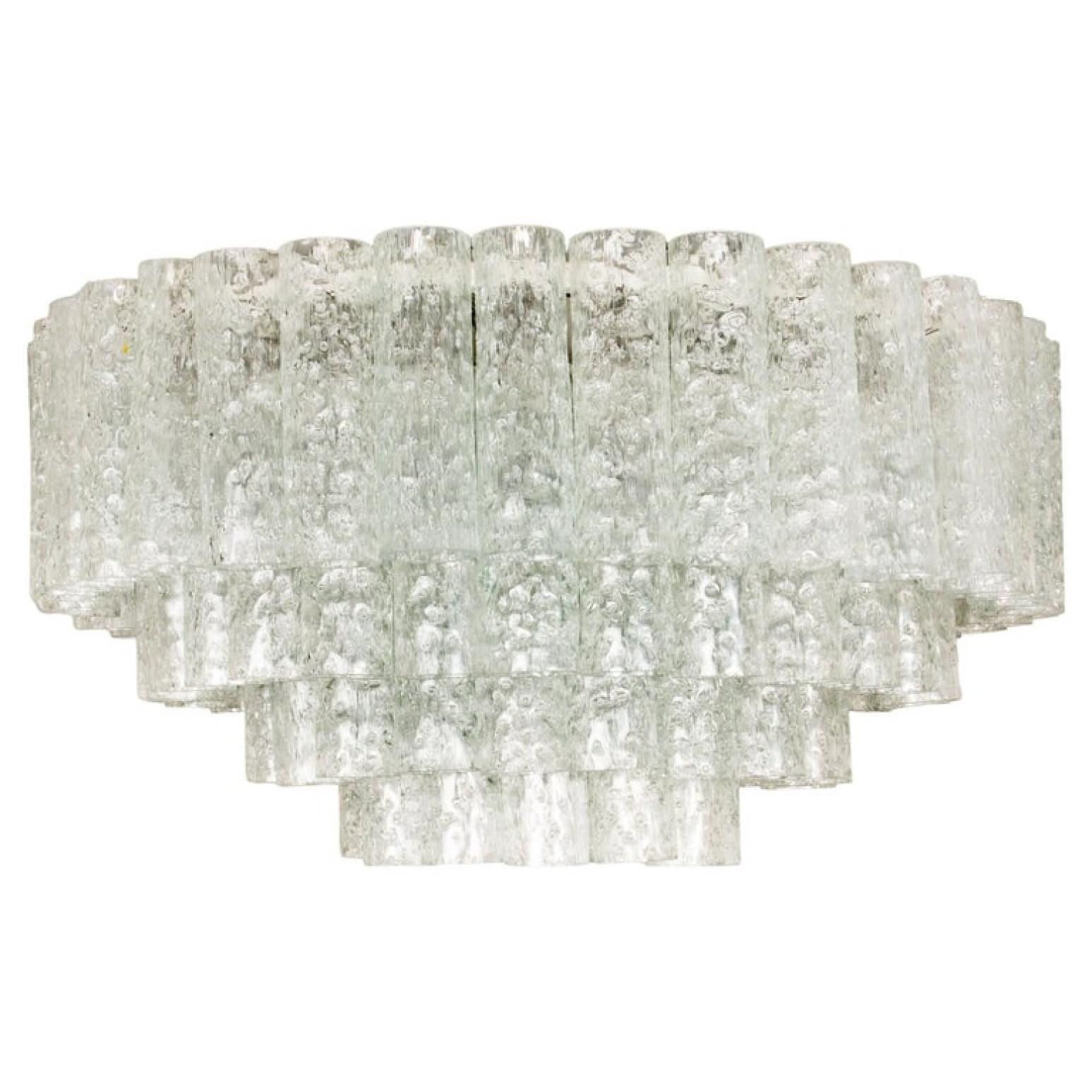 1 of the 2 of exceptional flush mount chandeliers by Doria, Germany, manufactured in circa 1970, (late 1960s and early 1970s). Four tiers bearing 96 separate blown Murano tubes of glass.

The stylish and clean elegance of this pair suits many