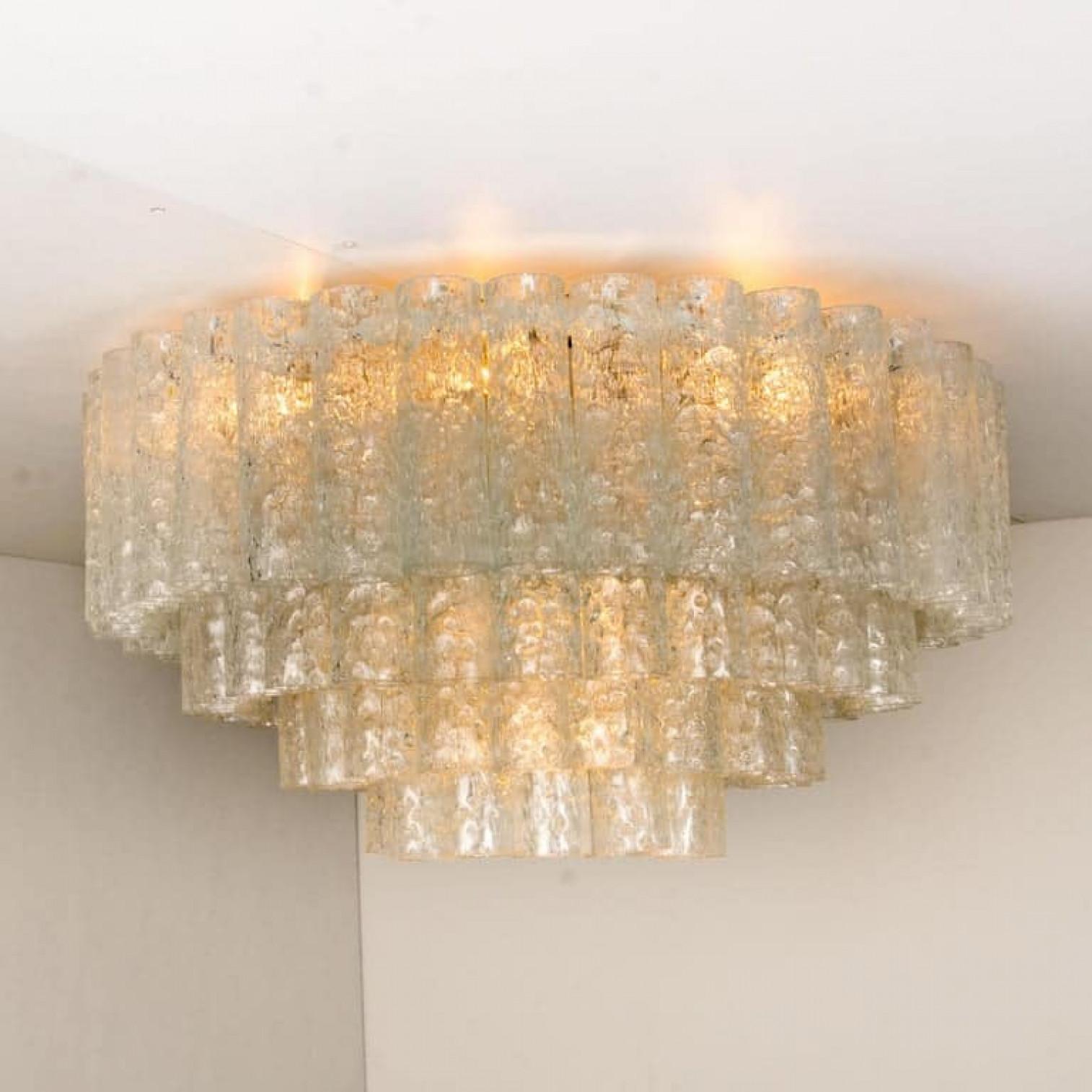 1 of the 2 of exceptional flush mount chandeliers by Doria, Germany, manufactured in circa 1970, (late 1960s and early 1970s). Four tiers bearing 96 separate blown Murano tubes of glass.

The stylish and clean elegance of this pair suits many