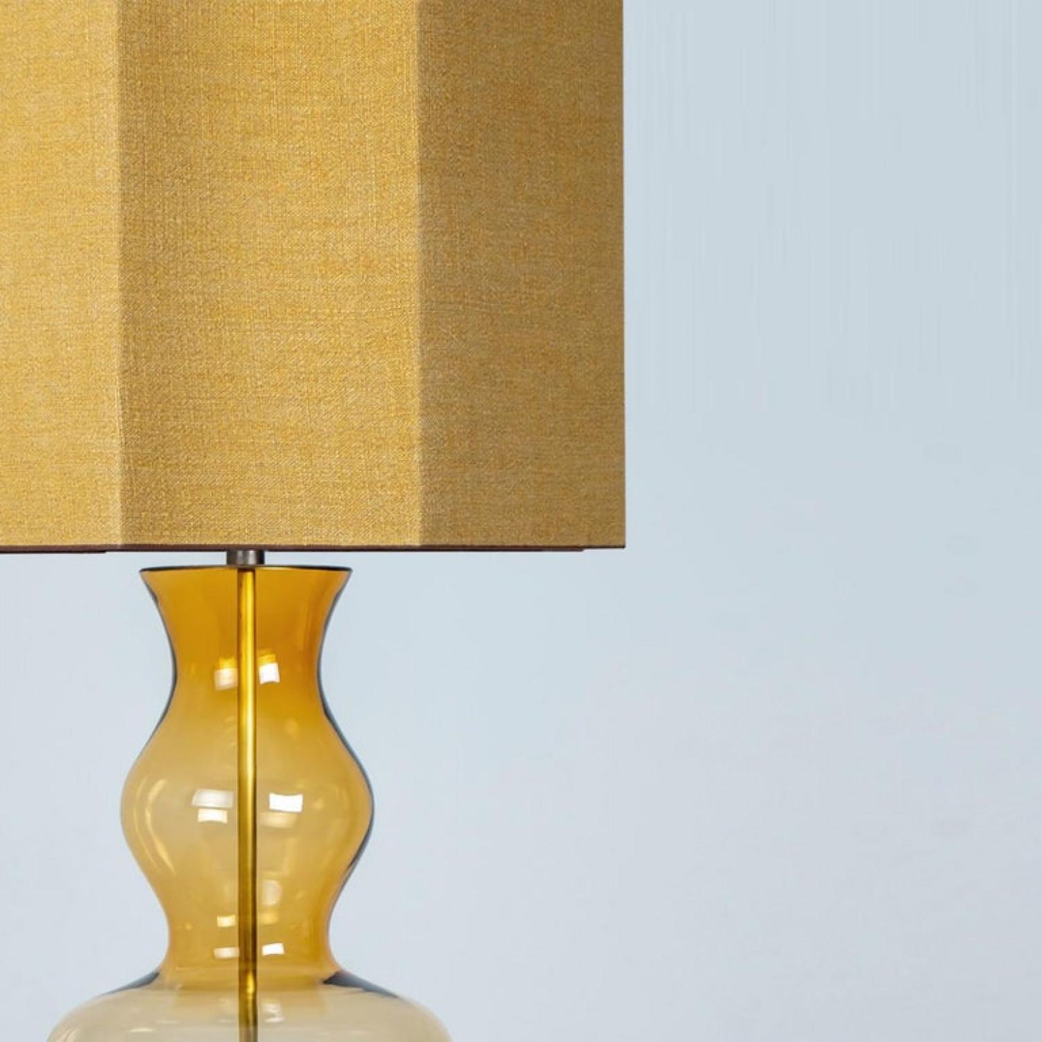 Unique Minimalist timeless design. Each extra large glass table lamp features a green exceptional transparent shaped base with a solid walnut wooden foot with old brass accents and a brass rod running through the center. Enhancing the light and