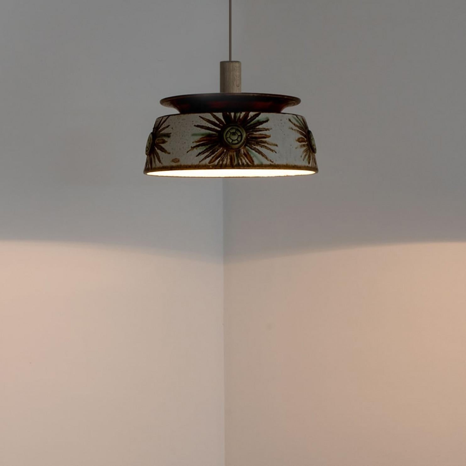 Splendida lampada a sospensione rotonda dalla forma insolita, realizzata in ceramica colorata in marrone e azzurro, prodotta negli anni '70 in Danimarca. Abbiamo anche una moltitudine di set e composizioni luminose in ceramica colorata, tutte