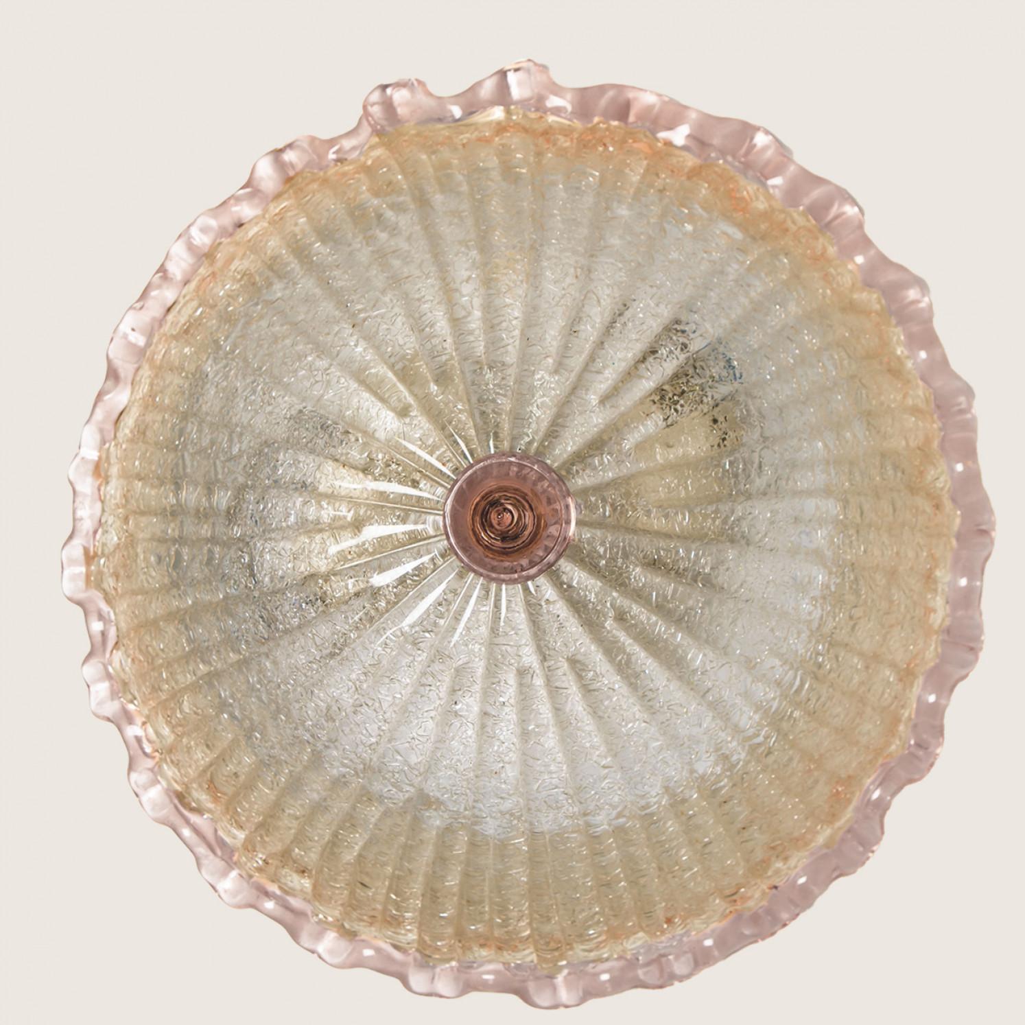 An elegant hand blown Murano glass flush mount in the style of Barovier & Toso. Mounted on a white frame. With pink and clear colored glass. The textured glass refract light beautifully. The flush mount fills the room with a soft, warm and welcoming