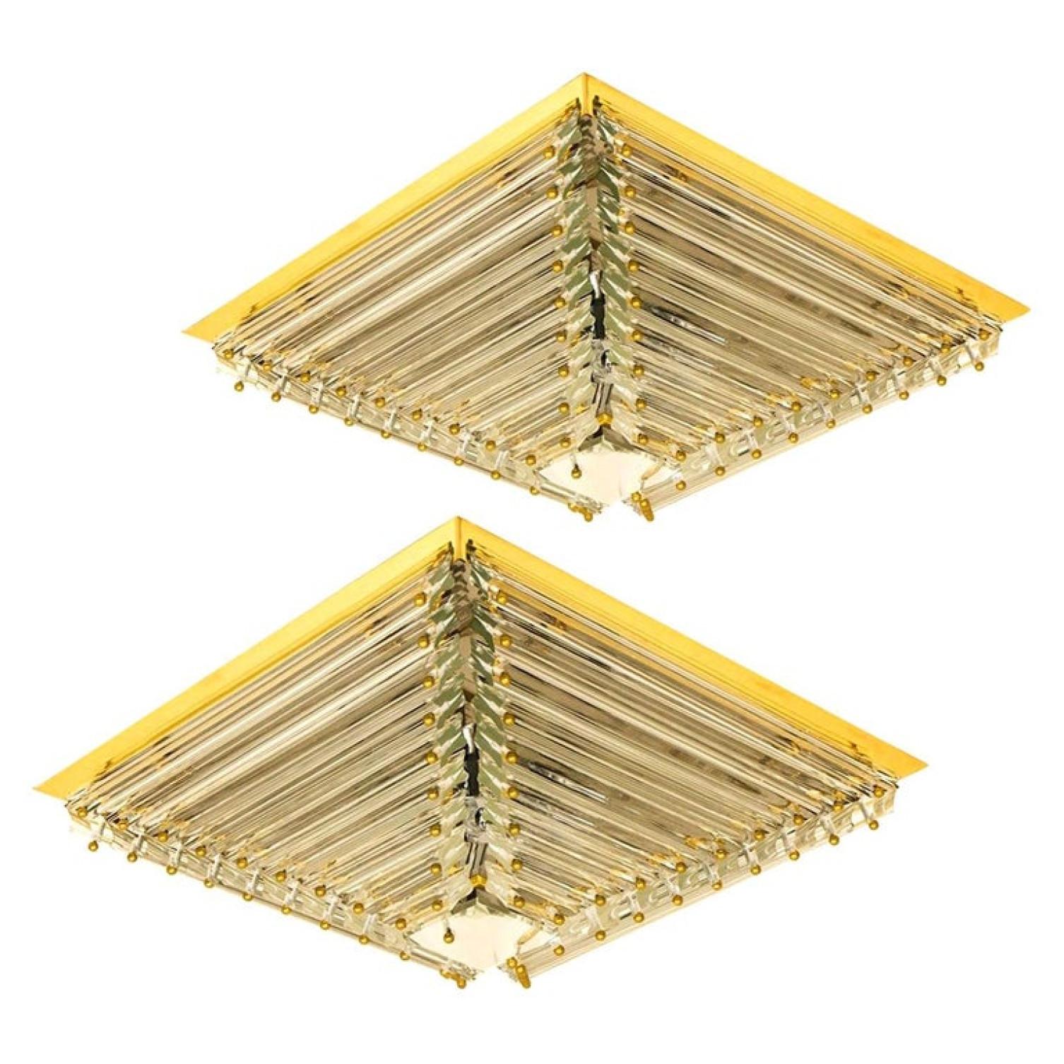 One of the two  gold-plated Venini flush mounts with faceted clear crystal tubes of Murano glass. Modellated in the form of a piramide. The flush mounts are designed and produced by Venini in Italy from the 1970s. The Murano tubes are suspended on a