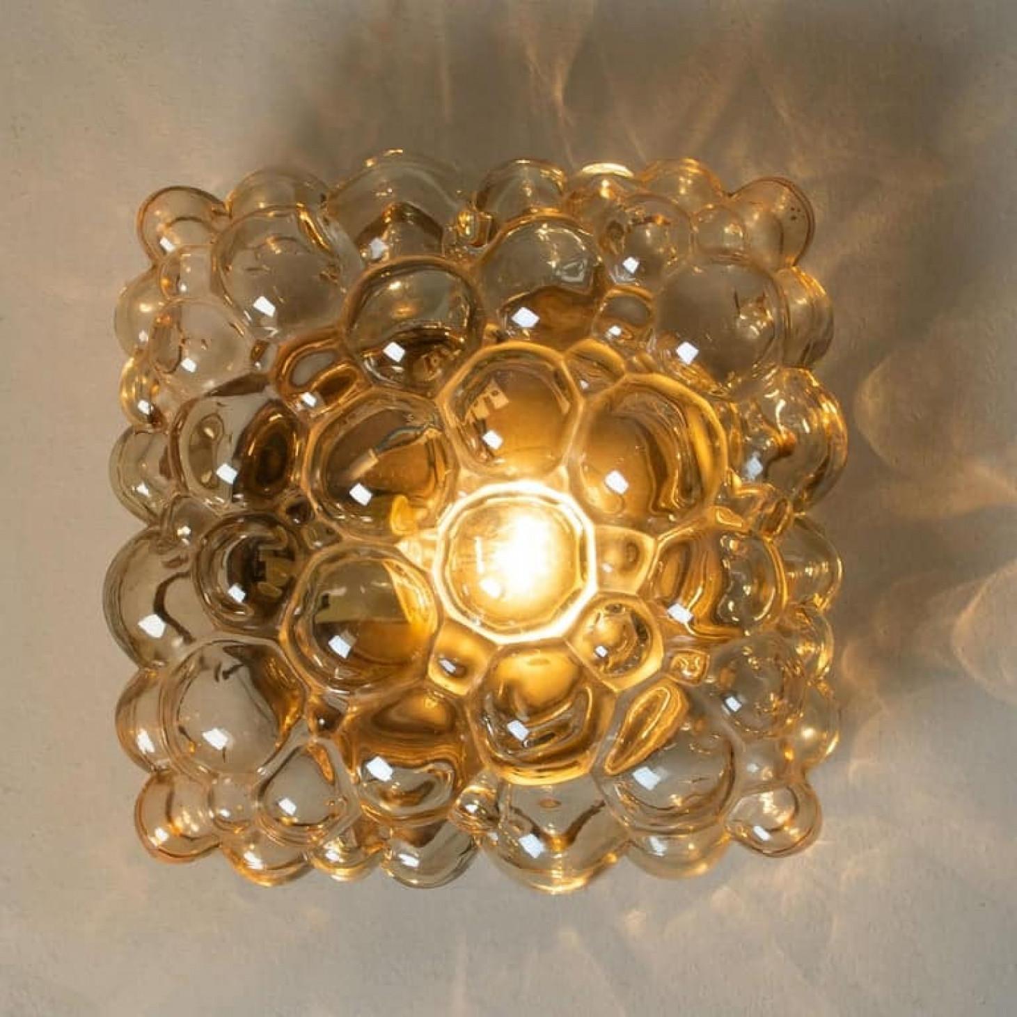 Beautiful high-end large bubble wall lights or flush mounts by Helena Tynell for Glashütte Limburg, Germany, 1960s.
A design Classic, made of glossy amber bubble glass.

The price is for single one. Two available. Can work as impressive wall lights