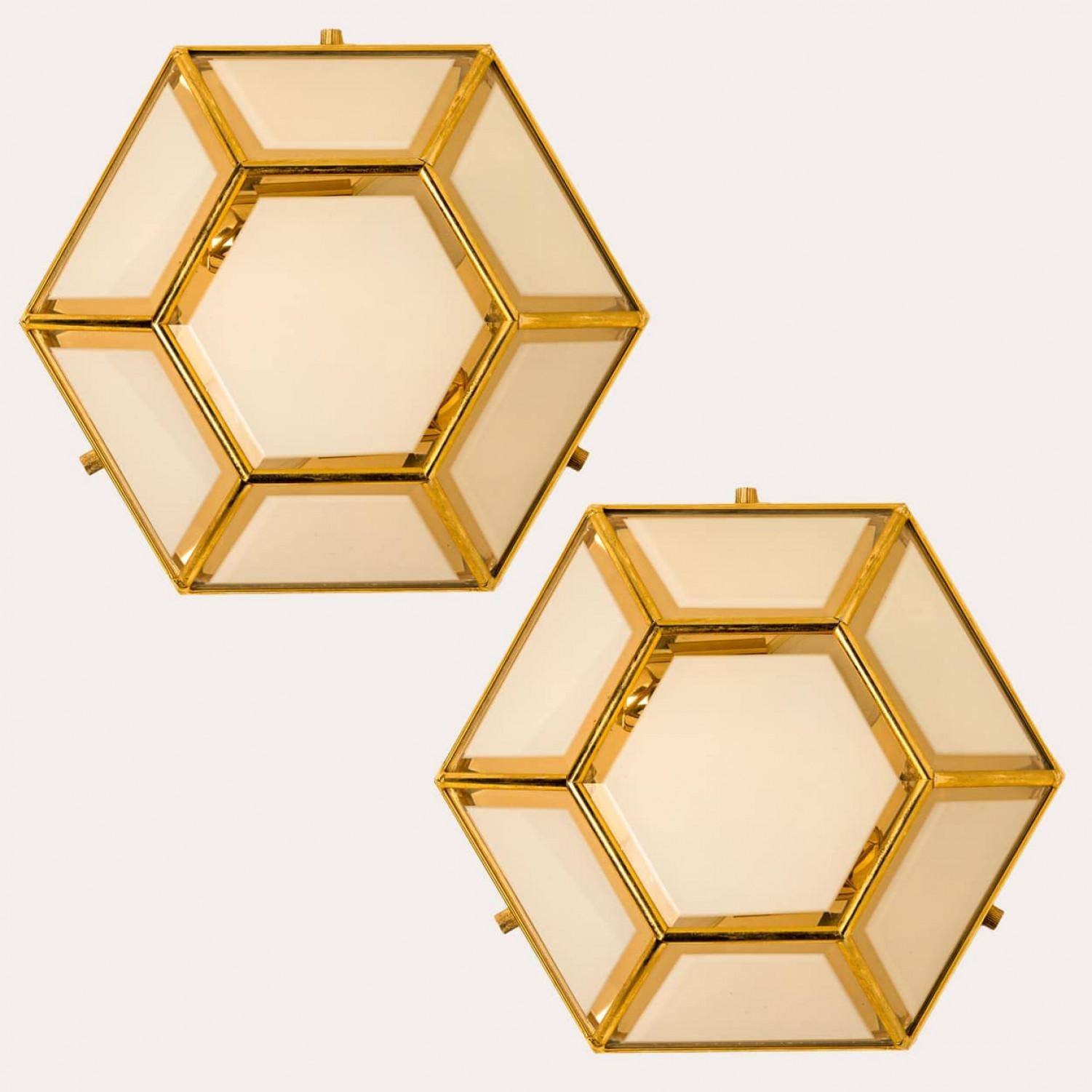 This beautiful and unique hexagonal glass light flush mount or wall light is manufactured in Germany during the 1970s, (early 1970s). Nice craftsmanship. Minimal, geometric and simply shaped design. Opal glass with brass frame.

Designed as ceiling