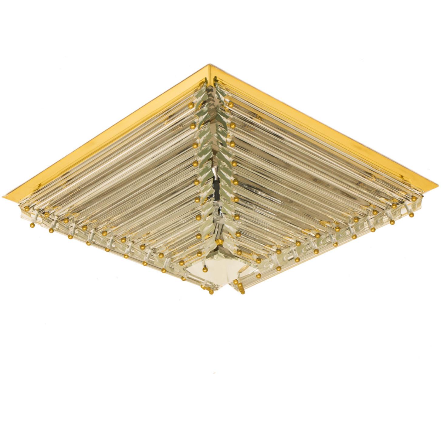 1 of the 2 gold-plated Venini flush mounts with faceted clear crystal tubes of Murano glass. Modellated in the form of a pyramid. The flush mounts are designed and produced by Venini in Italy from the 1970s. The Murano tubes are suspended on a