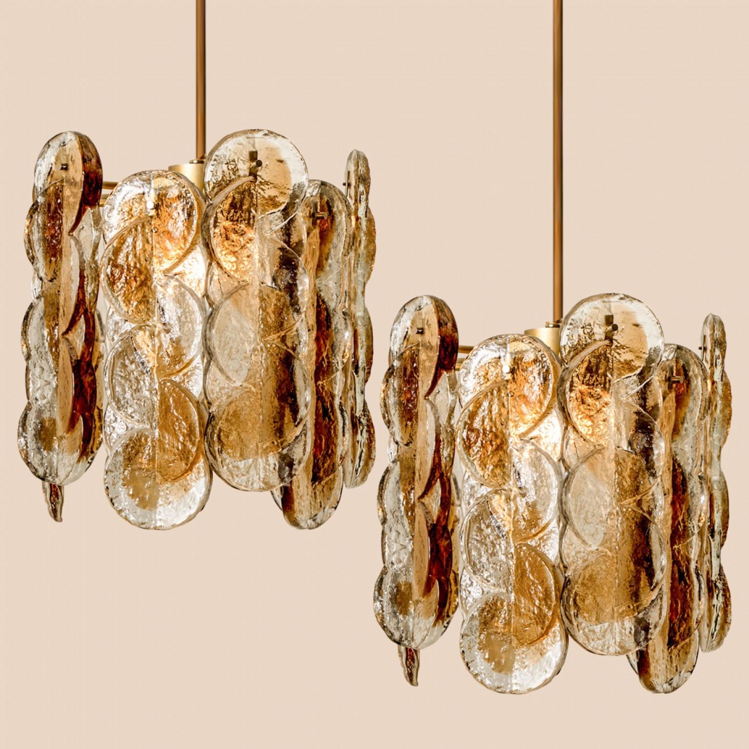 A  gorgeous murano glass pendant lights by Kalmar, 1960s. High quality smoked swirl ice glass, clear twisted crystal glass panels with a light gold dish amber colored stripe in it.

Heavy quality. Cleaned and well-wired, in full working order and