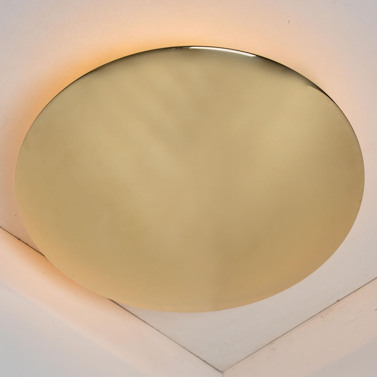 Pair of high quality brass flushmount ceiling lights 'Sela 50' by Florian Schulz. Slid brass in a tarnished finis dish with five bulb setup around that stem, the flushmounts can also be used as a wall lights.

The stylish and clean elegance of this