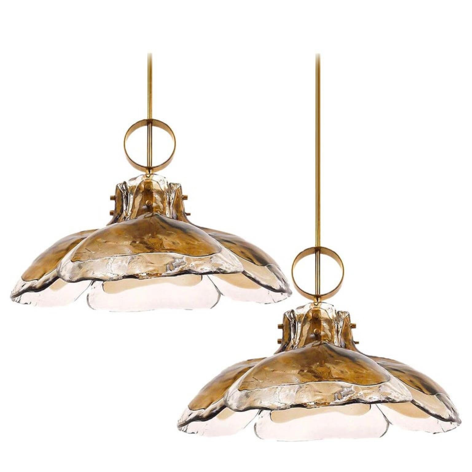 One of two beautiful midcentury brass chandeliers with four melting glass panels in the shape of a flower (diameter 20.7 inch / 51 cm). Illuminates beautifully.

Designed and executed by Kalmar Vienna in the 1970s. Hand blown melting glass, made of