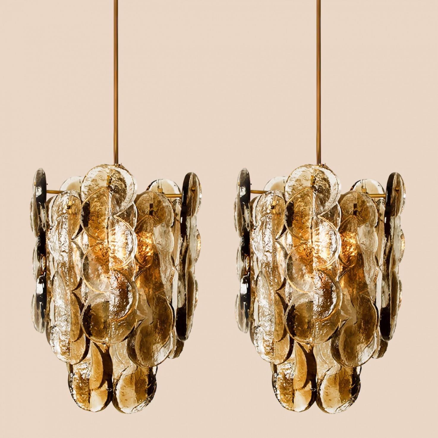 high quality murano glass chandelier by Kalmar, 1960s smoked swirl ice glass, clear twisted crystal glass panels with a light gold dish amber colored stripe in it.

Kalmar was the most important producer of premium-quality chandeliers in Austria