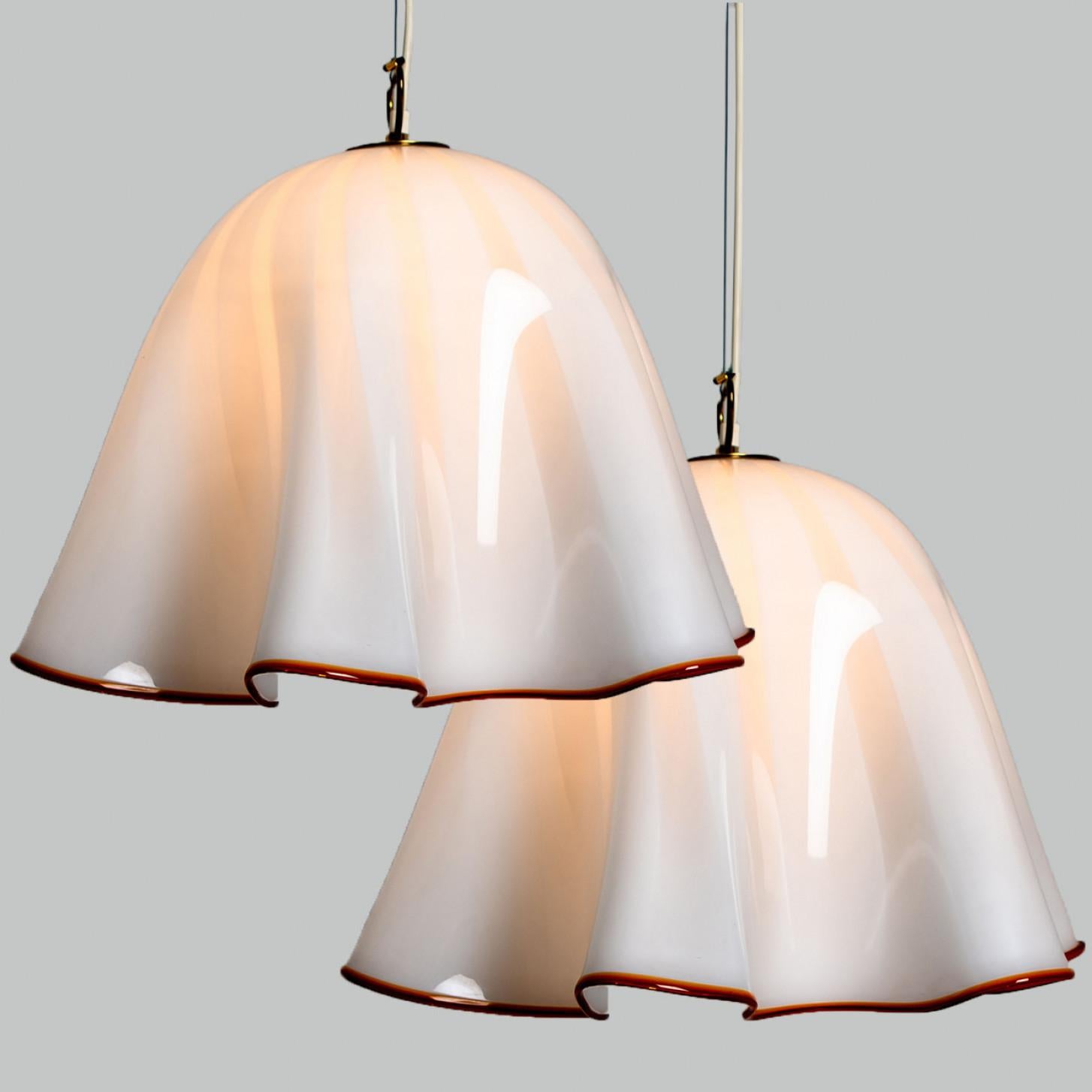 Large beautiful pendant light by J.T Kalmar. Manufactured in Austria, Europe, around 1970 (late 1960s, early 1970s). The Italian murano glass is hand blown.


The white opaque glass shows a red border. The lamps is in the style of 'Fazzoletto' glass