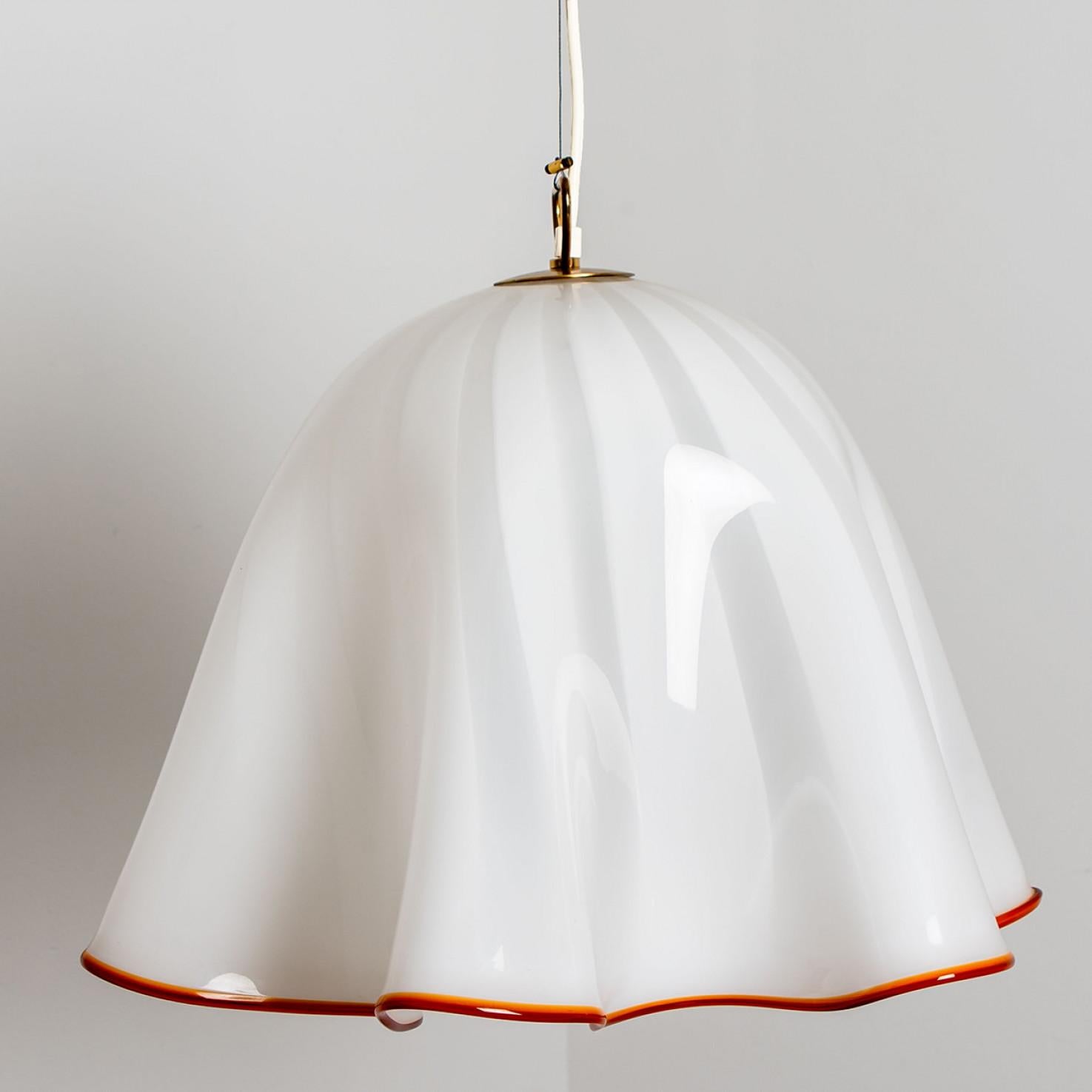 Large beautiful pendant light by J.T Kalmar. Manufactured in Austria, Europe, around 1970 (late 1960s, early 1970s). The Italian murano glass is hand blown.


The white opaque glass shows a red border. The lamps is in the style of 'Fazzoletto' glass
