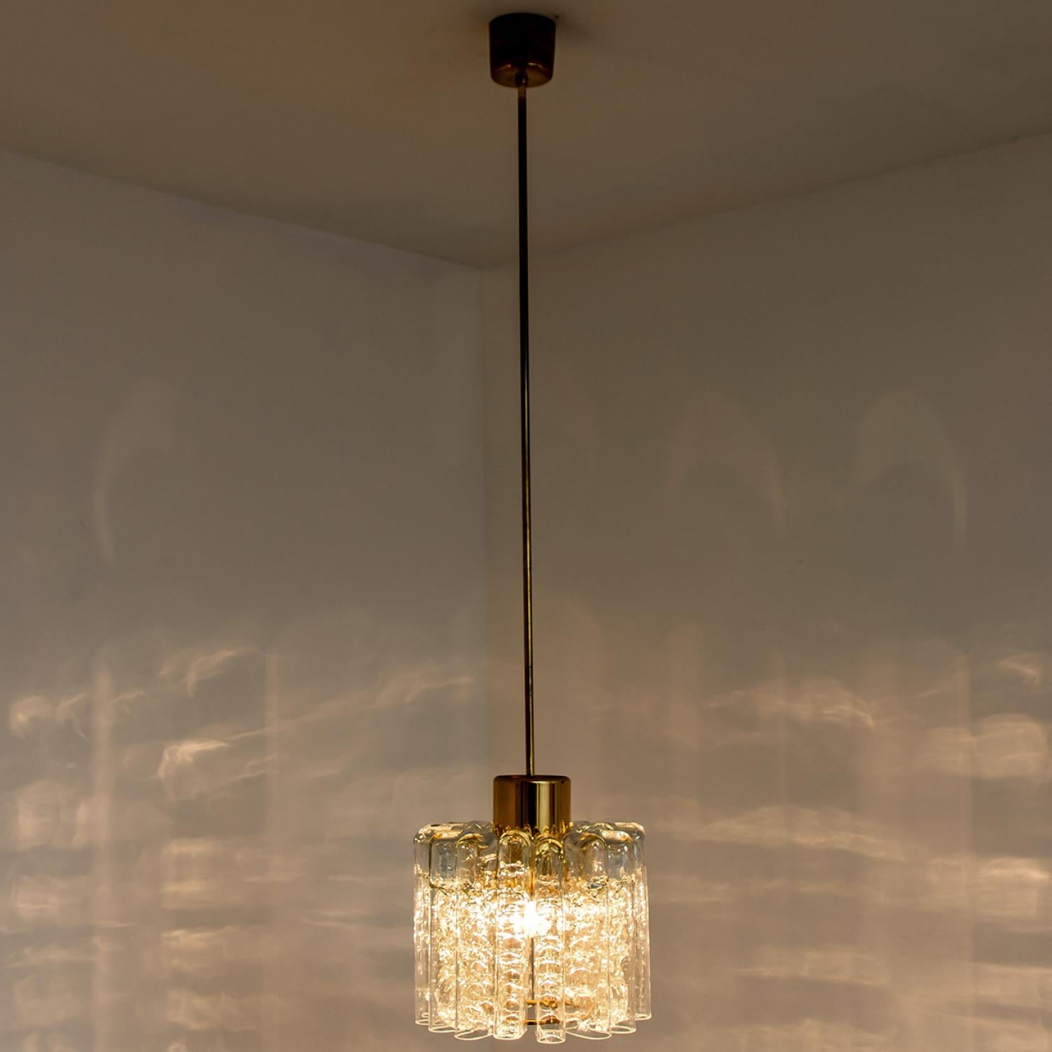 German 1 of the 2 Round Textured Clear Glass Doria Pendant Lamp, 1960s For Sale