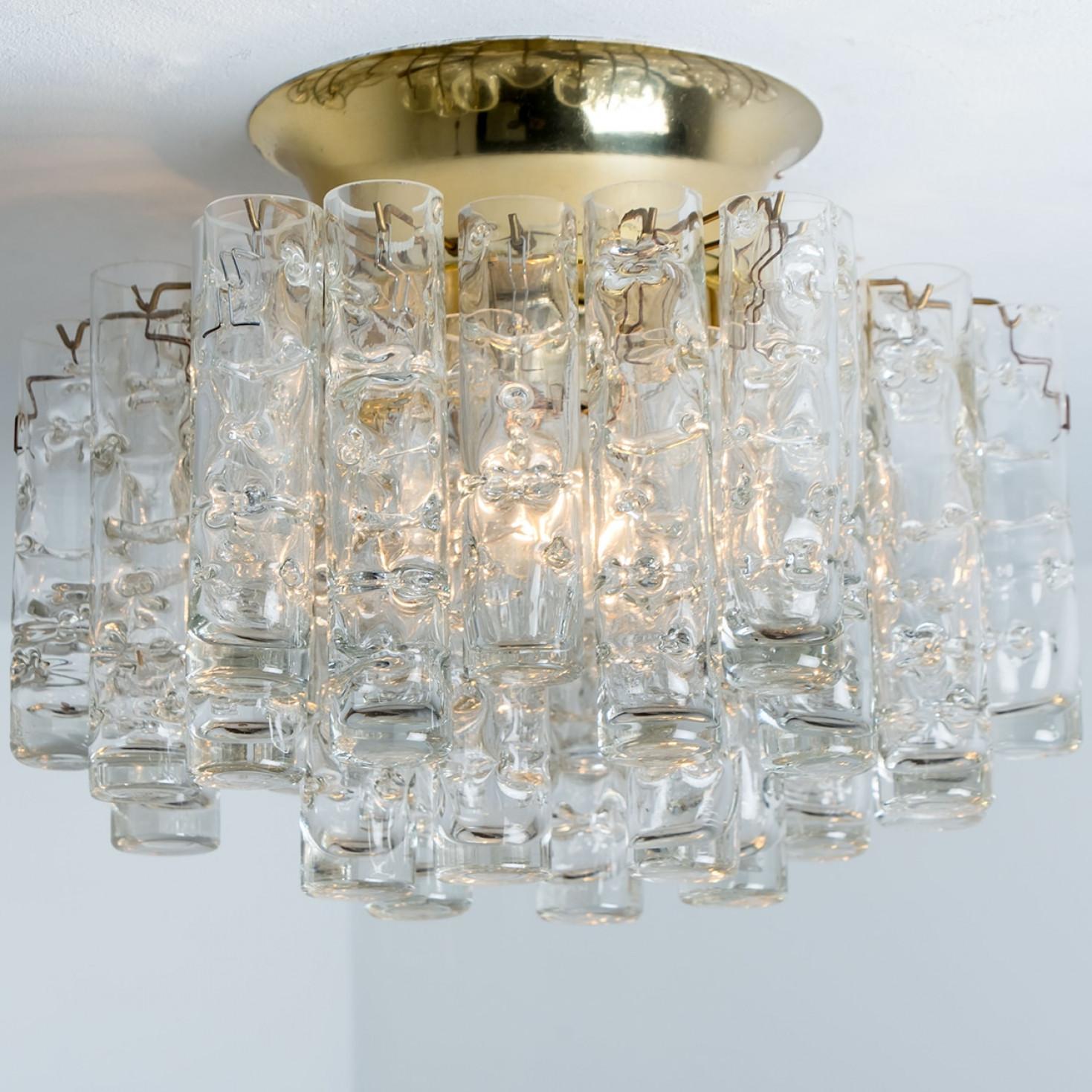 Star-shaped glass flush mount, manufactured by Doria Leuchten Germany in circa 1960.

This handmade light consists of a brass base with an array of high/end textured round tube-shaped art glass rods. Due the combination of materials, opal and clear