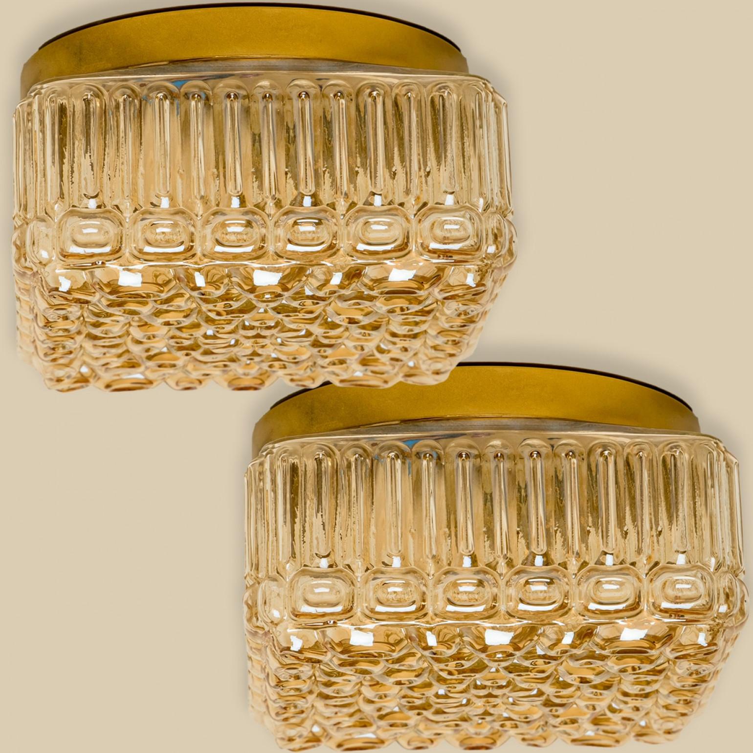 Elegant flush mount with a pattern of bubbles from amber glass in the style of Helena Tynell, made in Germany in the 1960s. This lamp features a blend of Mid-Century design with a stylish, minimalist aesthetic. The glass creates a beautiful