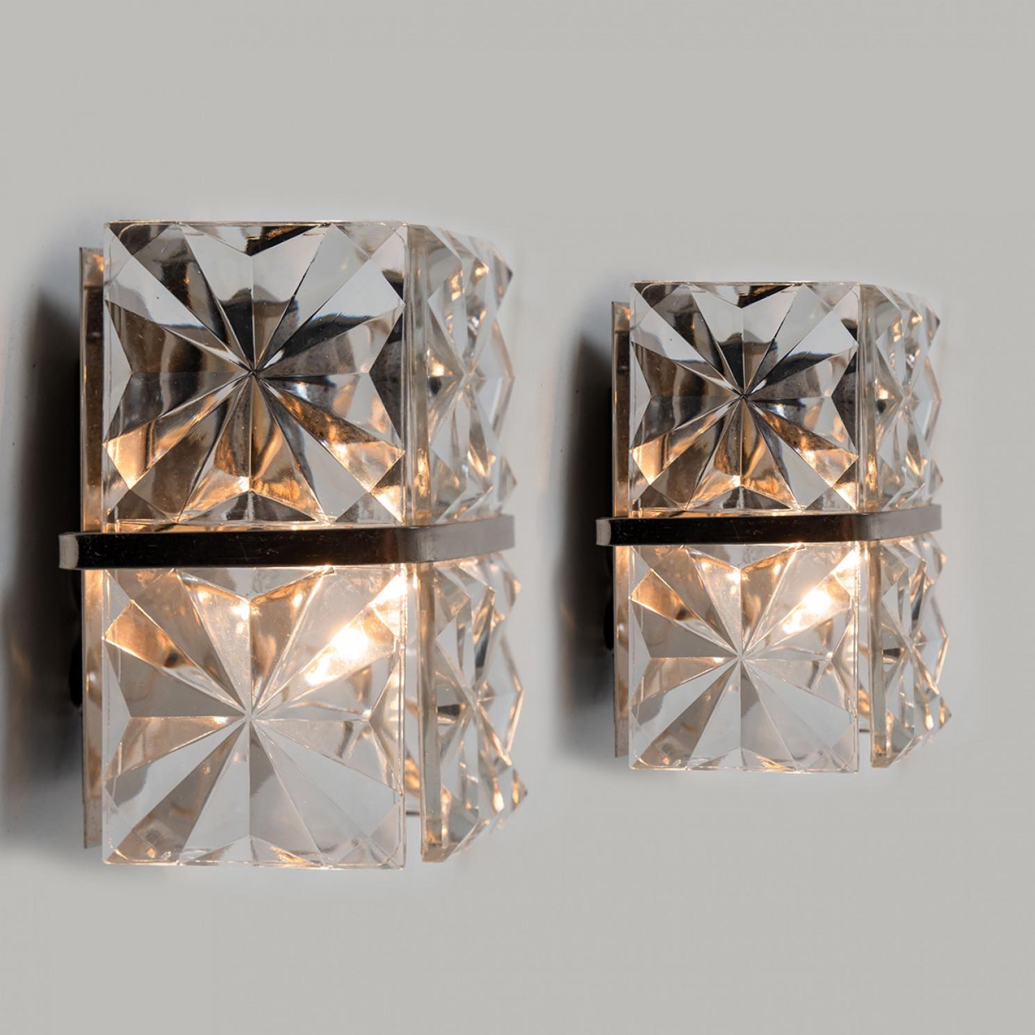 1 of the 2 luxurious of chrome frames and thick diamond crystal sconces by the famed maker, Kinkeldey. Very elegant light fixtures, comfortable with all decor periods. The crystals are meticulously cut in such a way that radiate the light of the