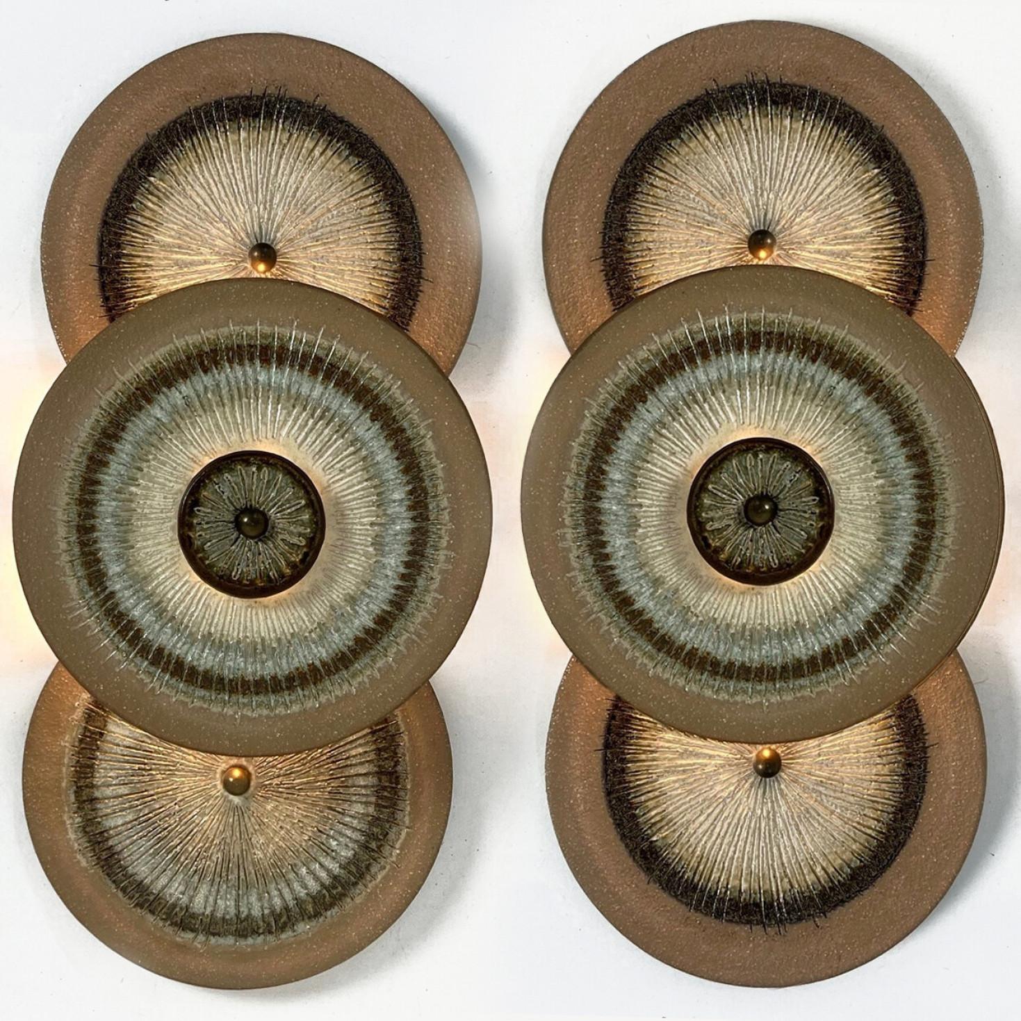 One of the Two spectacular circular ceramic wall lights, with beautiful  accents. Manufactured in Denmark in the 1970s.

A unique and playful set, real statement pieces in the room.

The lamps are Labelled and signed , in excellent condition. Axella