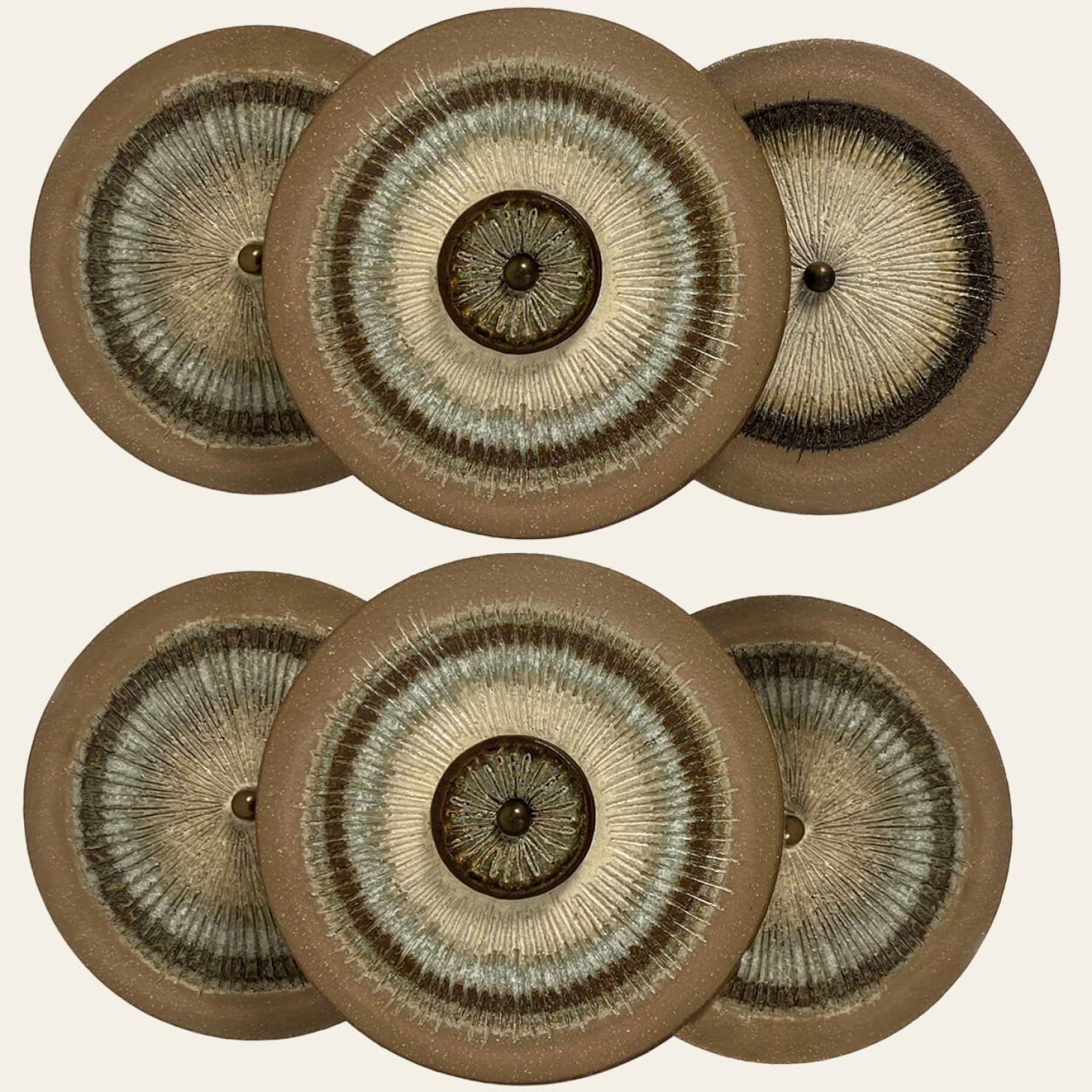 One of the Two spectacular circular ceramic wall lights, with beautiful  accents. Manufactured in Denmark in the 1970s.

A unique and playful set, real statement pieces in the room.

The lamps are Labelled and signed , in excellent condition. Axella