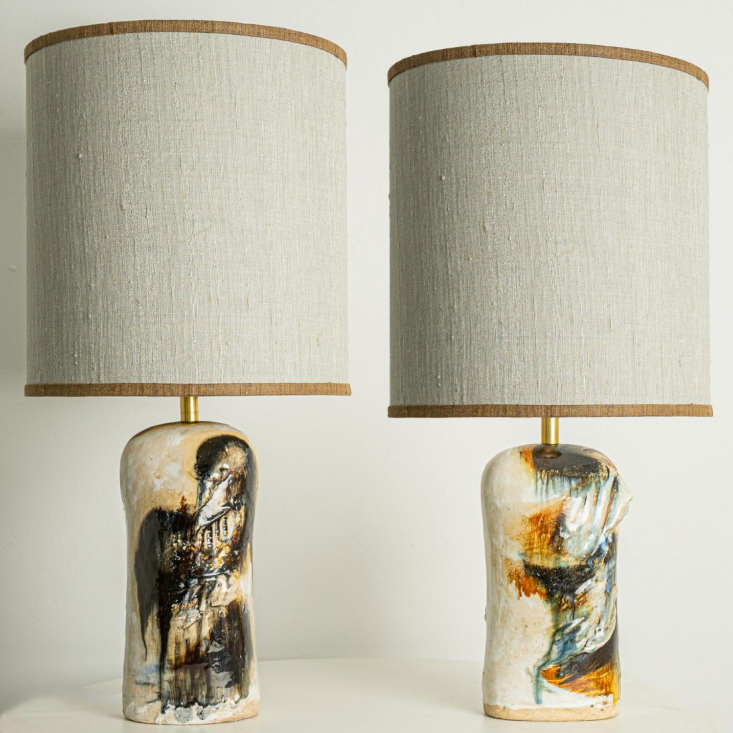 Beautiful floor table lamps by Jeppe Hagendorn, Denmark 1960s.

This stunning pair of ceramic bases with earthy tones and a beautiful glaze is a real eye catcher and a statement piece. The lampshade is designed by Rene Houben. This shades fit