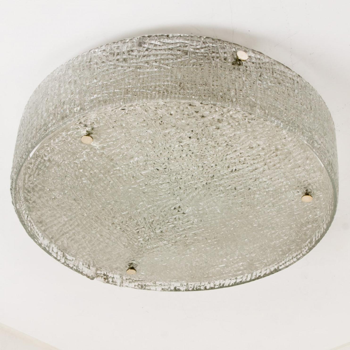 Gorgeous ice glass chandelier on a metal frame manufactured by Kaiser, Germany in the 1960s. The lamp takes three large Edison bulbs. Rare to find in this huge size.
Two pieces of thick textured clear glass placed to a frame (white metal) with metal