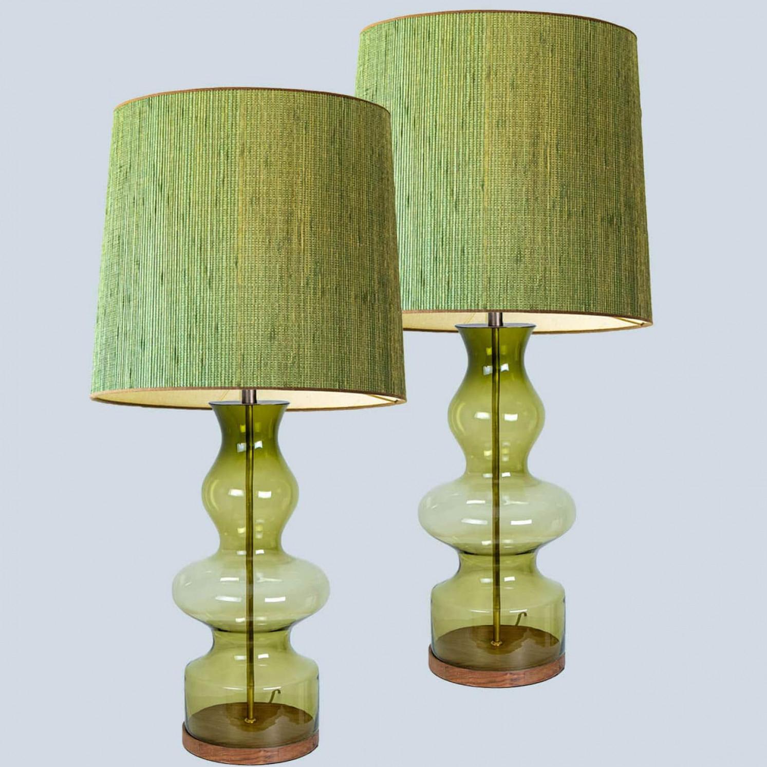 A unique Minimalist timeless design. Each extra large glass table lamp features a green exceptional transparent shaped base with a solid walnut wooden foot with old brass accents and a brass rod running through the center. Enhancing the light and