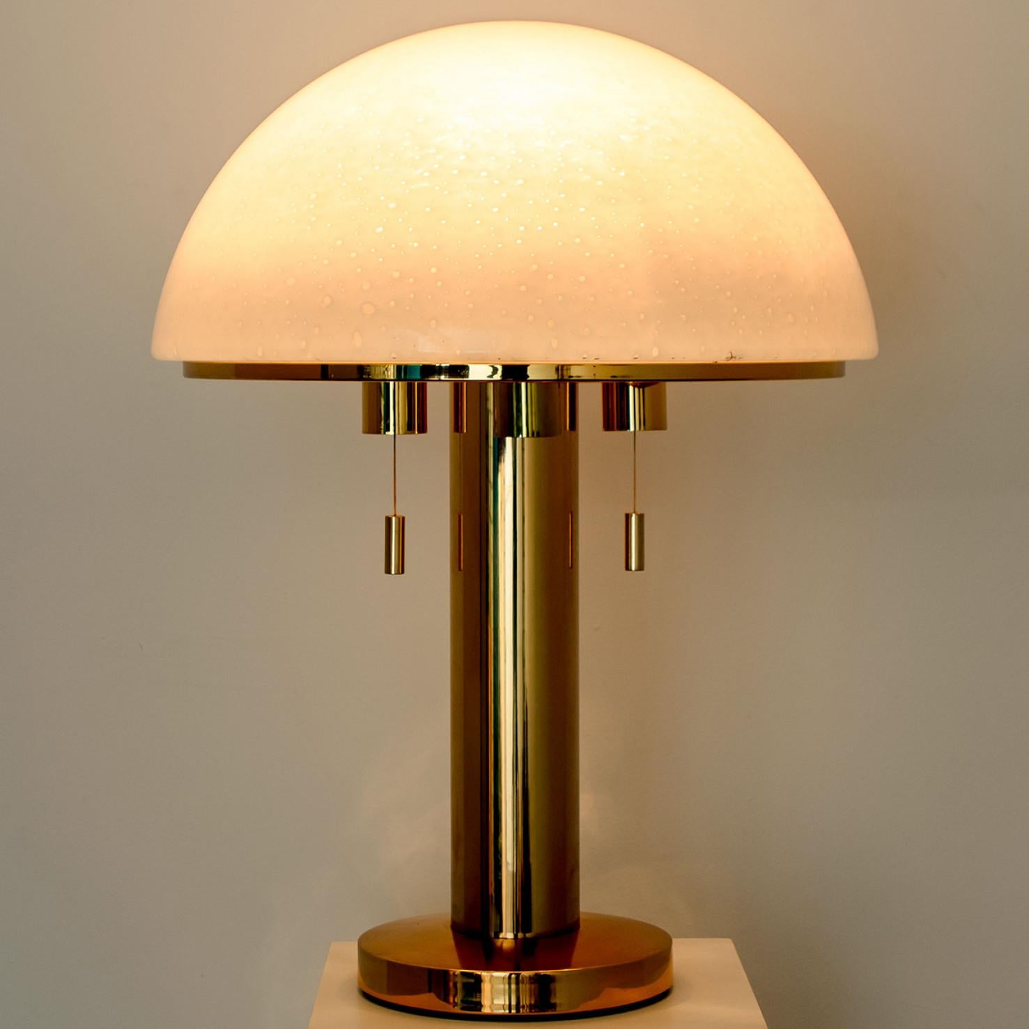 Mushroom table lamp with white satin glass and a brass base. Designed and manufactured by Limburg Glashütte, Germany in 1970.
The lamp has the organic shape of a mushroom. It is in perfect condition, great design from the 70's.

Dimensions:
Height:
