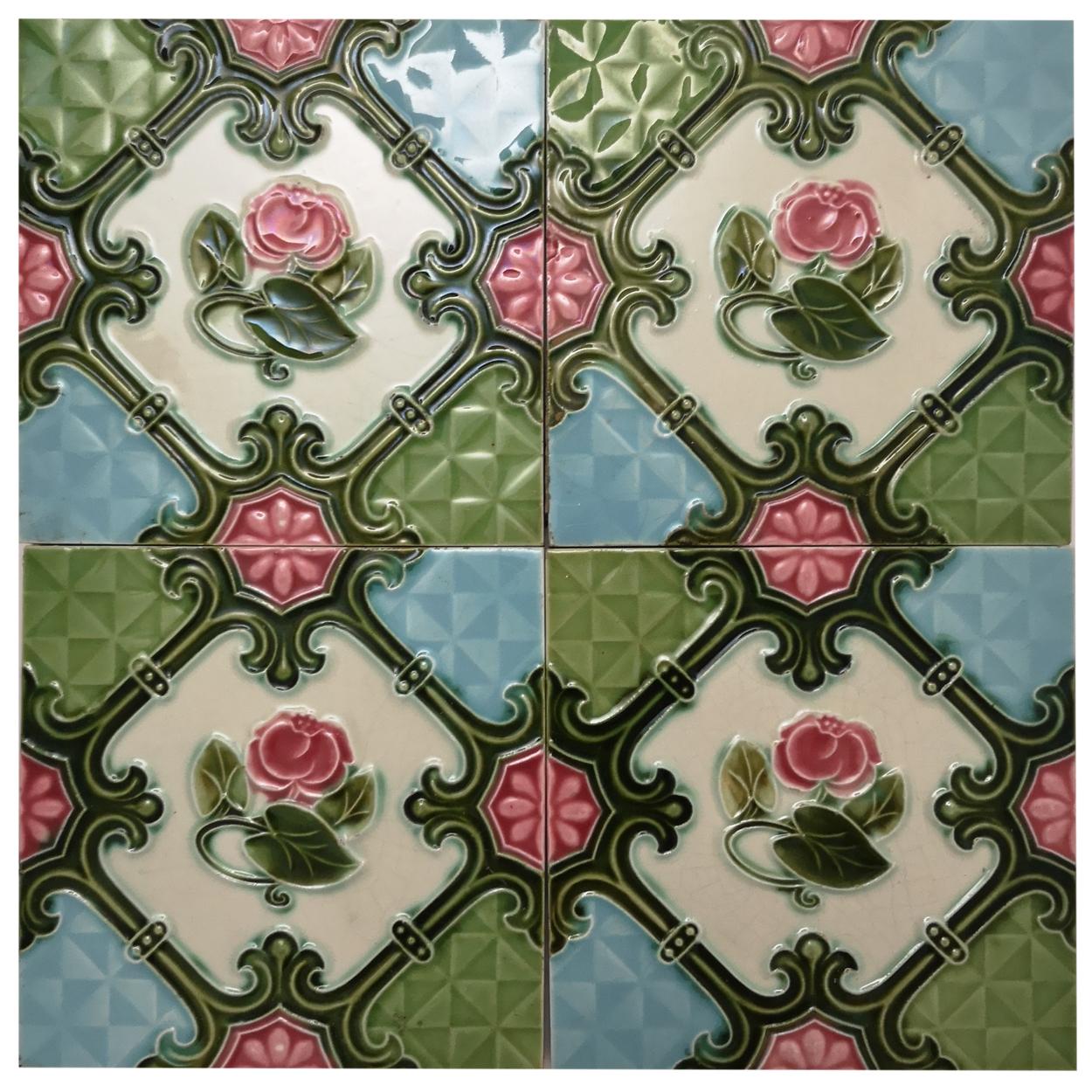 This is an amazing set of antique Art Nouveau handmade tiles S.A. Produits Ceramiques de la Dyle. 1930s. 
A beautiful relief and deep rich rose deep green, and creme color. These tiles would be charming displayed on easels, framed or incorporated