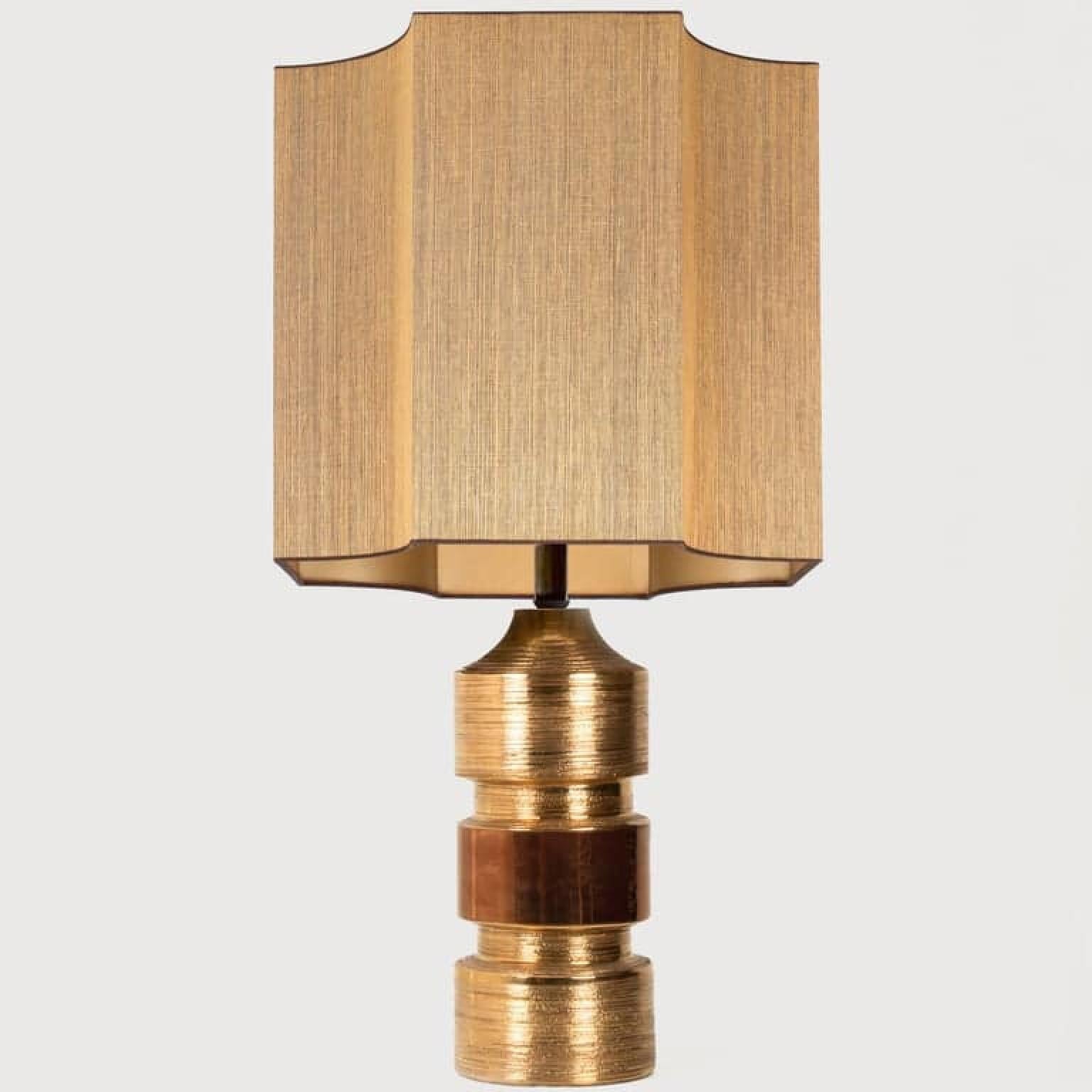 Exceptional set Bitossi lamps with a ceramic base with shiny metallic gold glaze. Bitossi for Bergboms, Italy, circa 1960s. With an exceptional custom made shades by René Houben. With warm gold inner-shade.

Approximate dimensions:
Lamp ceramic only