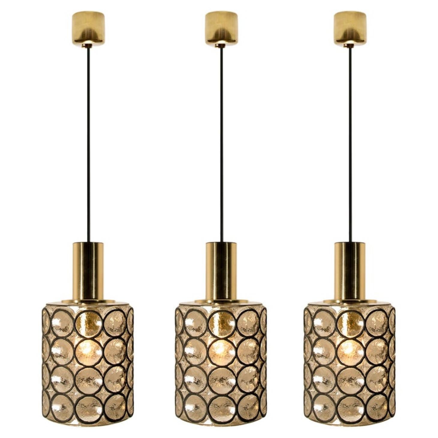 Minimal, geometric and simply shaped design. This beautiful and unique pair of hand blown glass chandeliers/pedant lights were manufactured by Glashütte Limburg in Germany during the 1960s (late 1960s or early 1970s). Beautiful craftsmanship. These