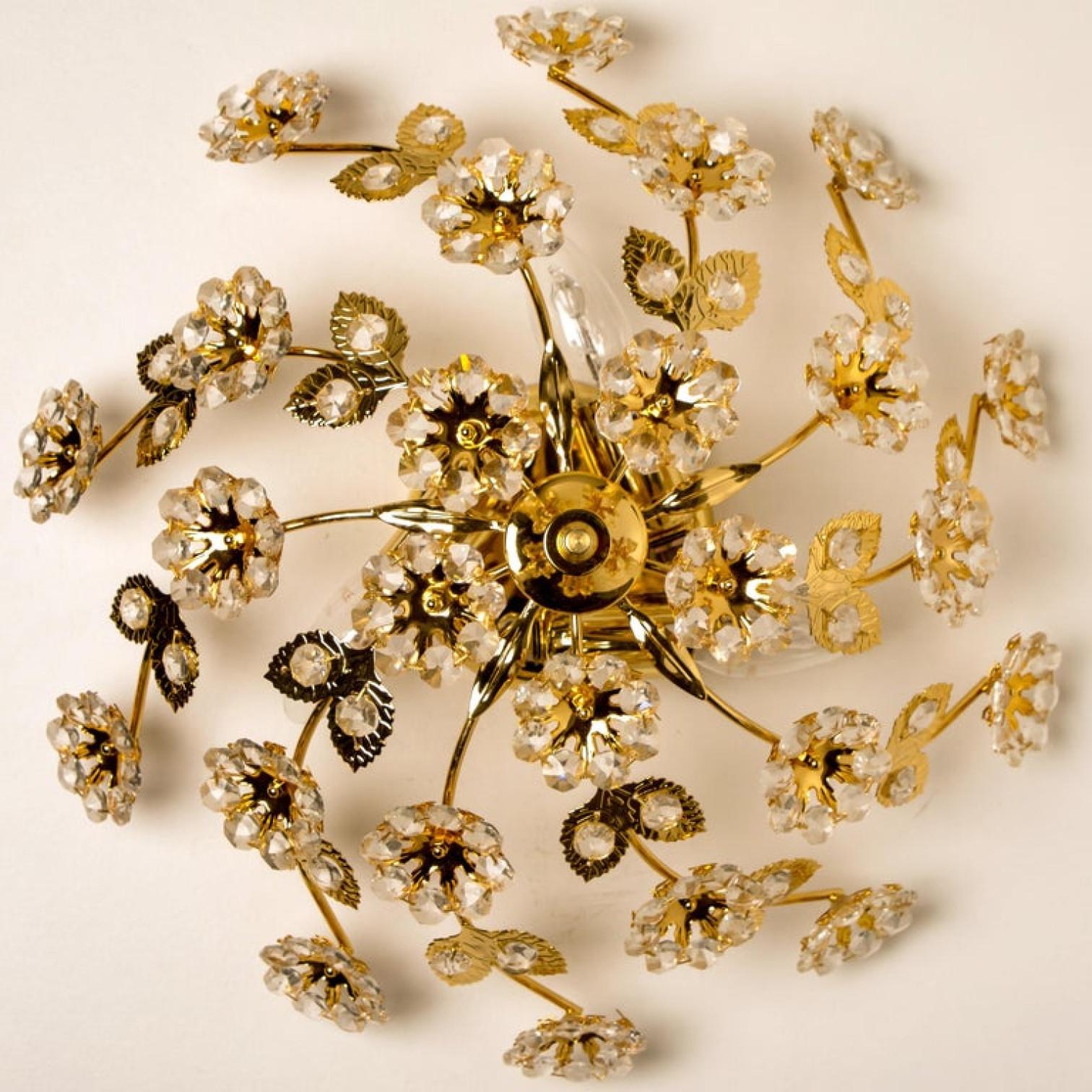 Stunning flower wall light/ flush mount by Palwa, Germany, circa 1965-1975.
A luxurious of light fixture with beautifully cut flower crystals on a gold plated brass frame.

Please notice the price is for one, 3 pieces available.
In very good
