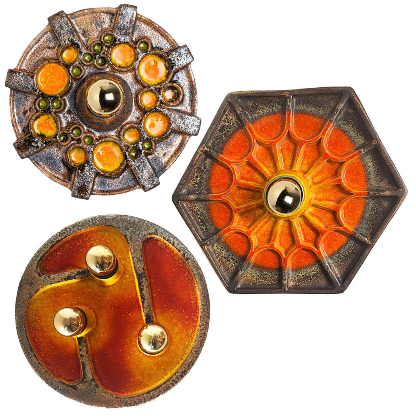An exceptional set of  Orange/Braun Ceramic wall lights. Manufactured in Germany in the 1970s.

The set shows a playful variety of colors. The glaze of the set has a dark orange, green and a grayish brown color.

The fixtures can also by used as
