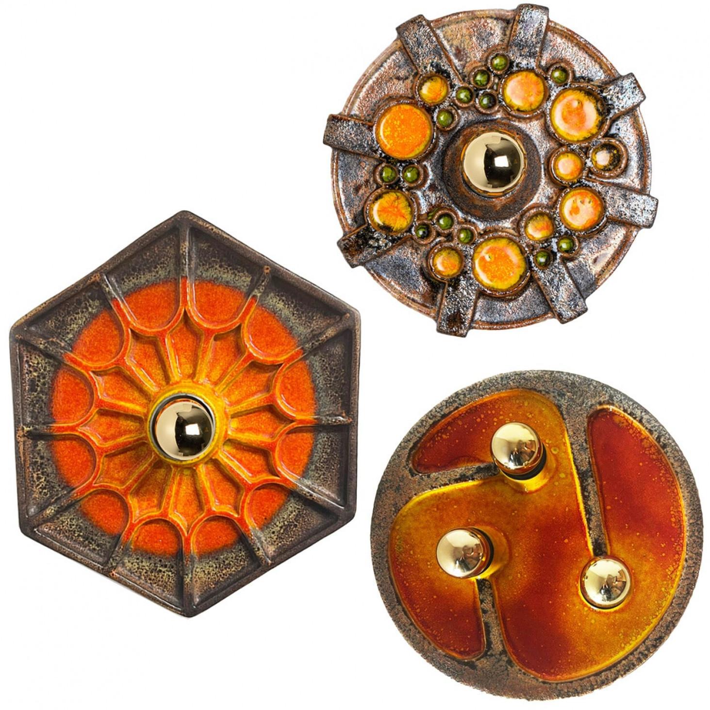 An exceptional set of  Orange/Braun Ceramic wall lights. Manufactured in Germany in the 1970s.

The set shows a playful variety of colors. The glaze of the set has a dark orange, green and a grayish brown color.

The fixtures can also by used as