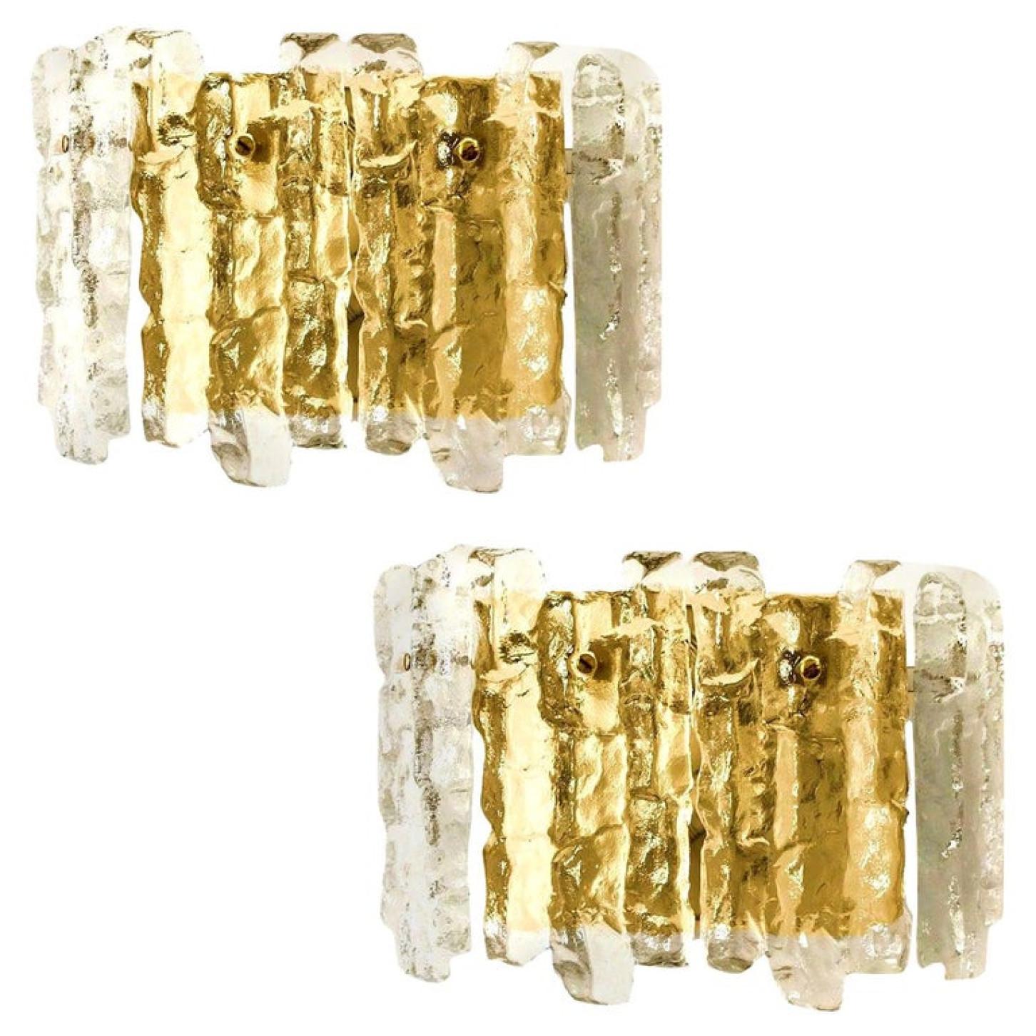 Pair of elegant modern high-end large brass wall lights or sconces, manufactured by J.T. Kalmar, Austria in the 1970s. Lovely design, executed to a very high standard. Each wall light has four solid ice glass sheets dangling on it. Clean lines to