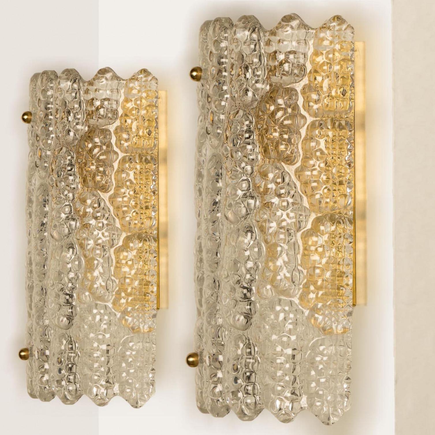 Fantastic mid-century nice textured glass wall lights by Carl Fagerlund for Orrefors, released between the 1950s & 1960s. Beautiful vintage wall lamp with brass screws and brass wall part in combination with thick glass from the Orrefros glass