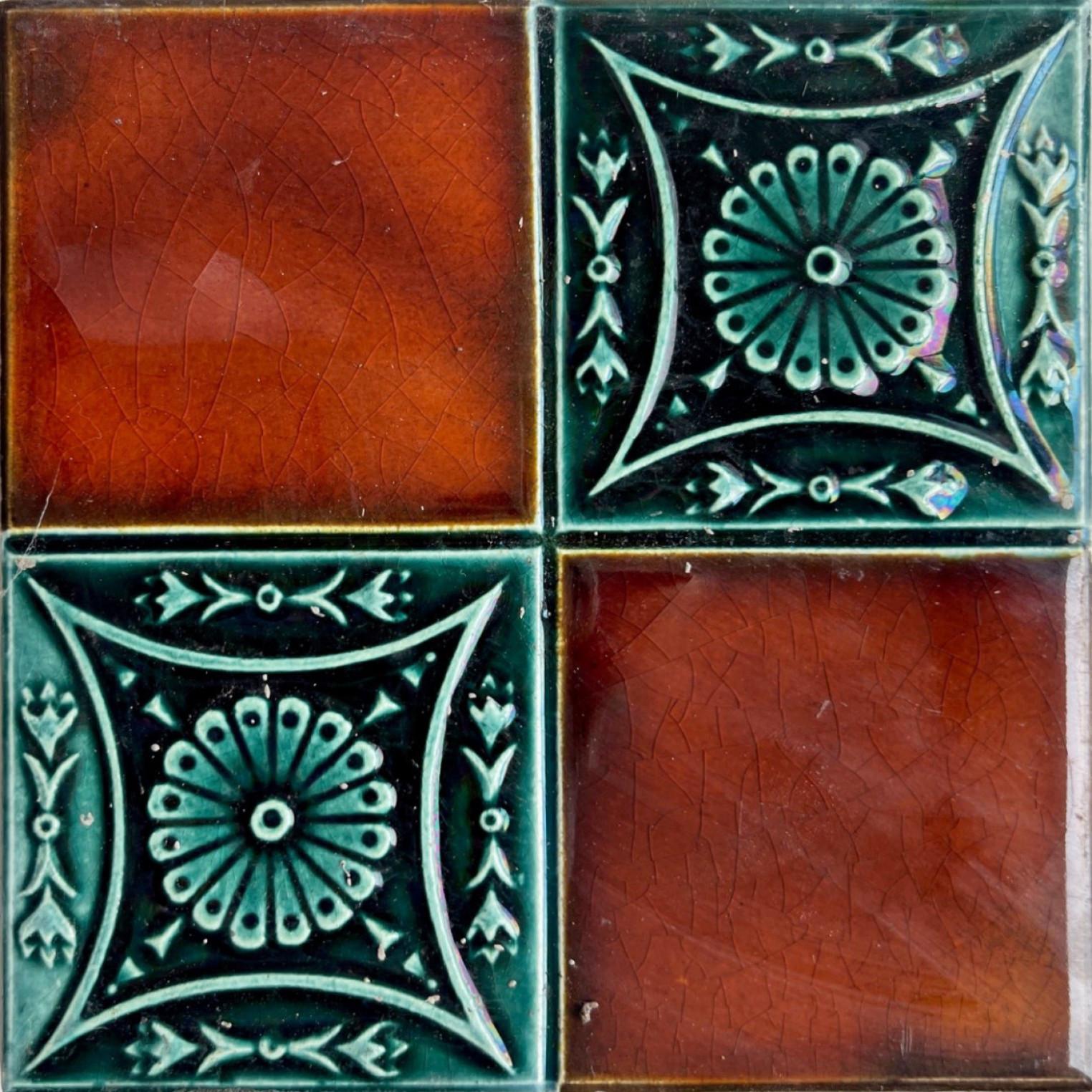 1 of the 30 handmade antique tiles in rich brown and green glazed colors. Manufactured around 1920 by Gilliot Hemiksem, Belgium. One tile is divided in four squares, two brown and two relief green. These tiles would be charming displayed on easels,