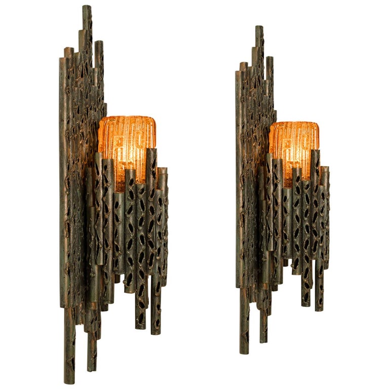 1 of the 4 impressive and rare Brutalist one-light sconces made of patinated handcrafted metal. Fitted with beautiful textured golden or orange color Murano glass to cover light bulbs. Designed by Marcello Fantoni, circa 1970s.

Cleaned and