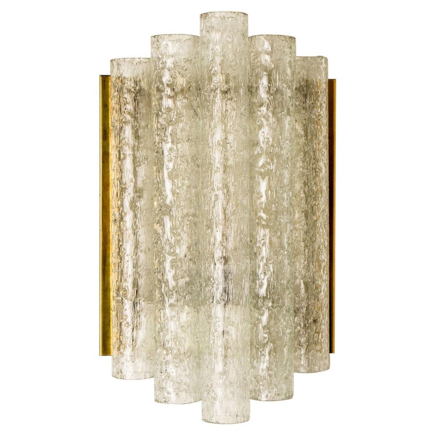 This wall lamp is designed by Doria. The wall fixture is made from brass, chrome (from the side) and metal and it features four thick hand blown glass tubes with gold flakes. Each wall lights takes an E14 max. 40W bulbs. Wonderful light effect due