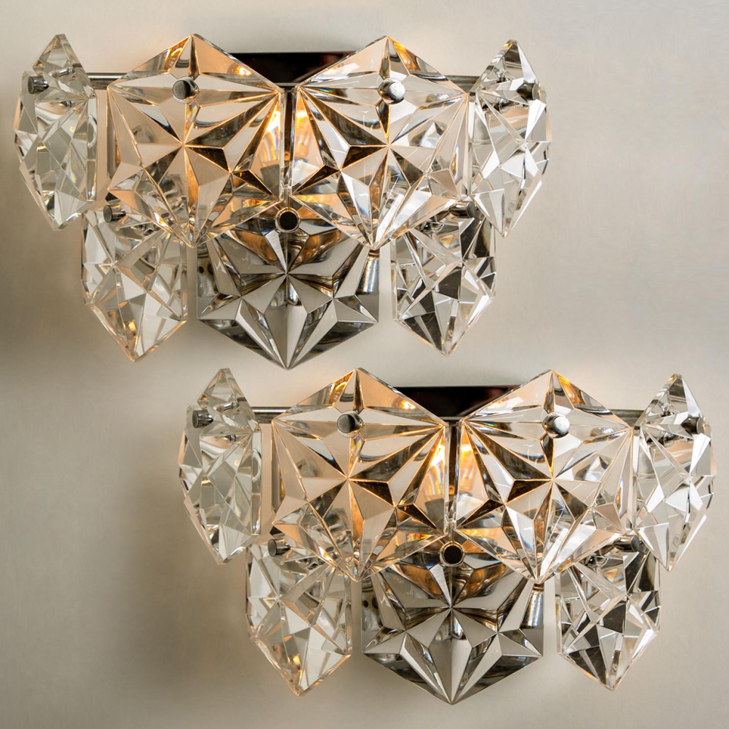 1 of the 4 luxurious of chrome frames and thick diamond crystal sconces by the famed maker, Kinkeldey. Very elegant light fixtures, comfortable with all decor periods. The crystals are meticulously cut in such a way that radiate the light of the