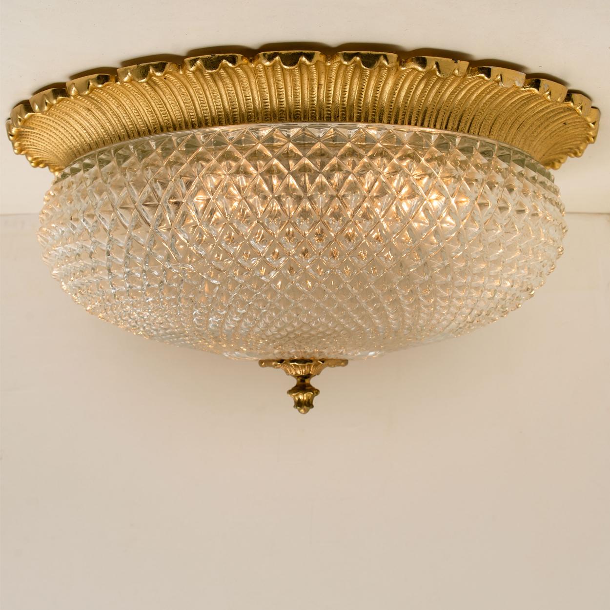 A glass flushmount by Limburg in Germany, 1970s. High-end pieces. Thick textured glass fixture on a brass metal base.

Measures: Large Ø 19.7