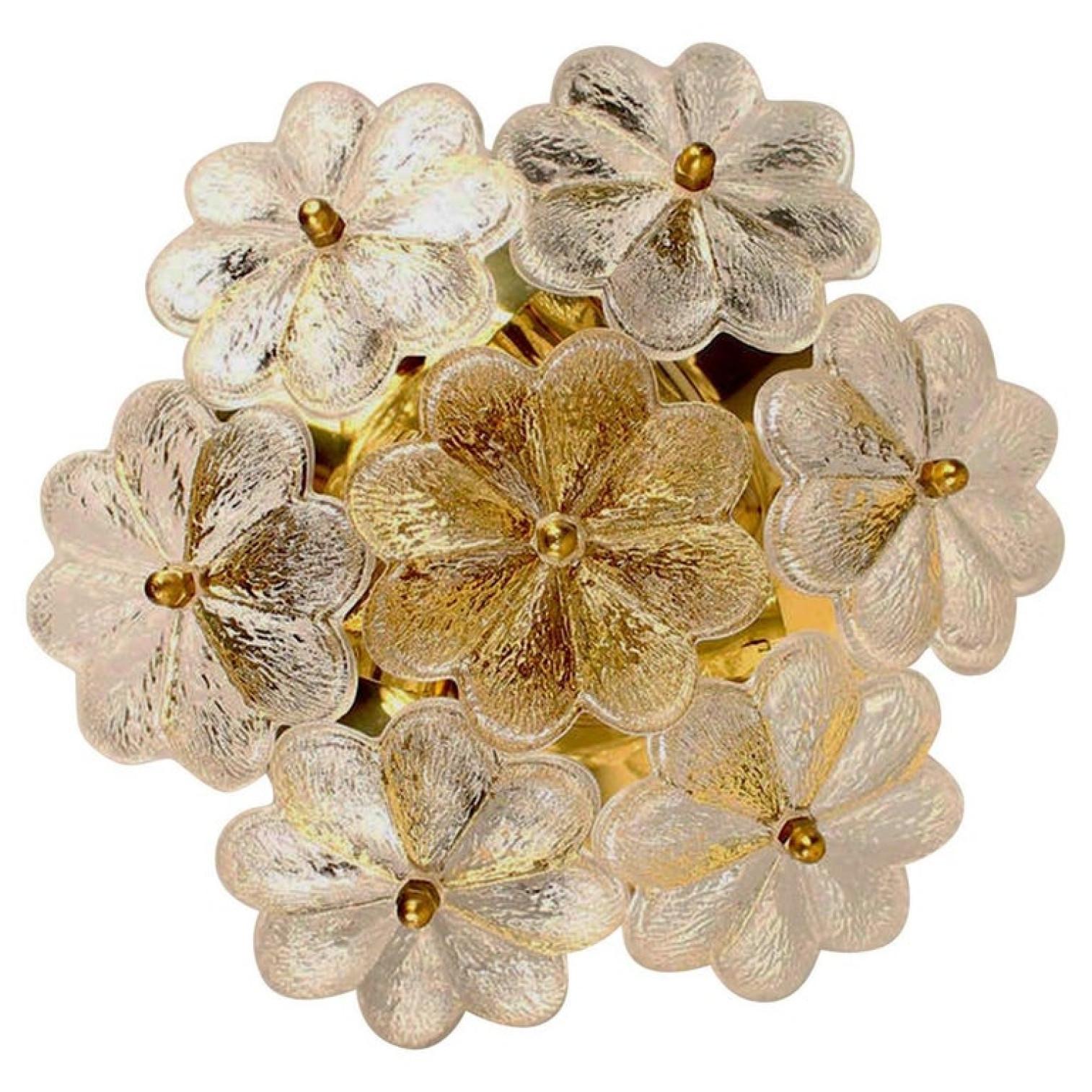 These sculptural wall sconces have the design of a bouquet of textured glass flowers and are from the historical lighting company Ernst Palme. Each light has seven glass shades.

Each clear glass flower shade has textured petals and is securely