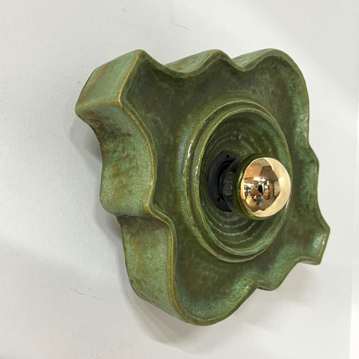 1 of the 5 Green ceramic wall lights in Fat Lava style. Manufactured in Germany in the 1970s.

The style of the glaze is called 'Fat Lava'. Which means the glaze is thick on some parts, like lava.
A typical way to finish ceramic in mid-century