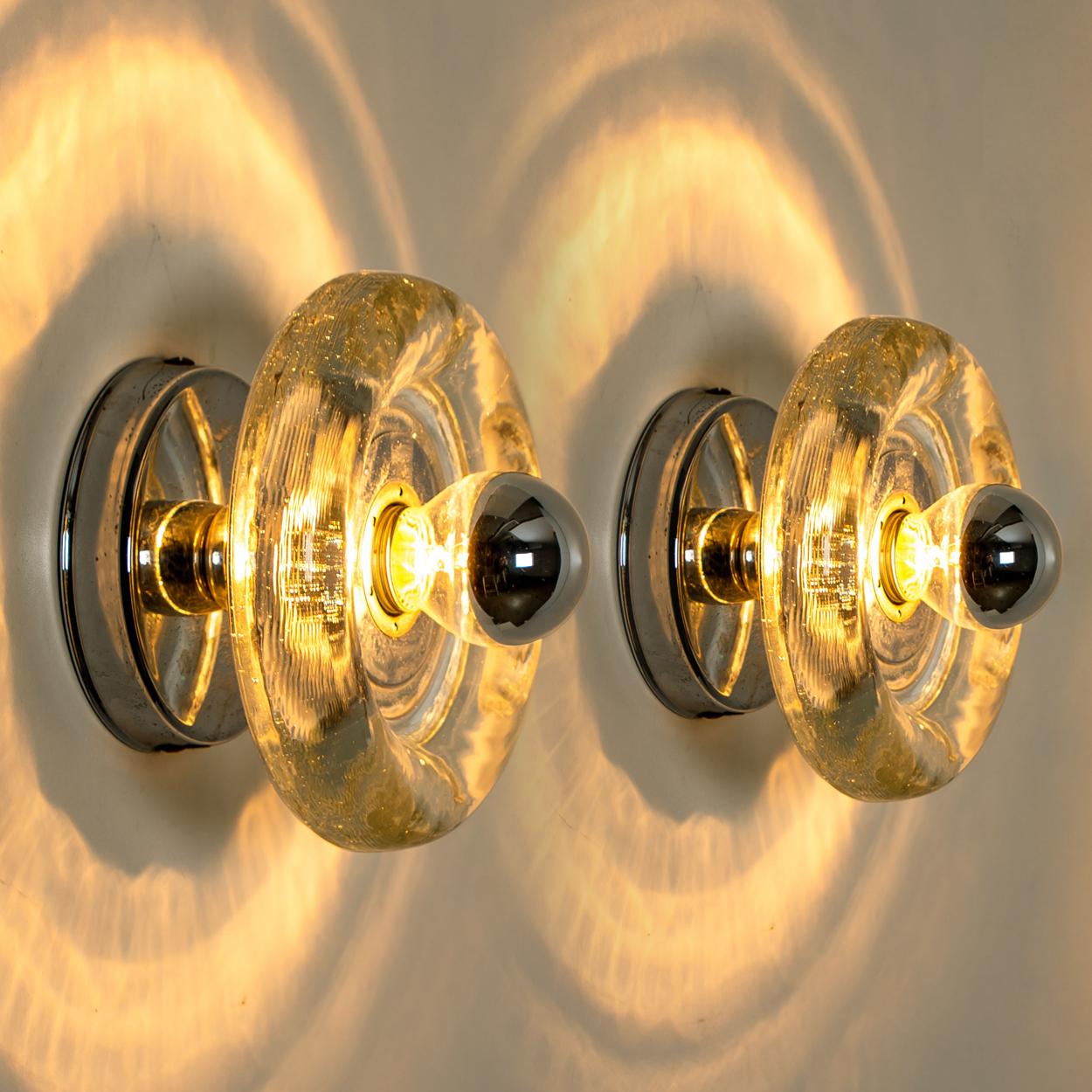 One of the 4 Doria lights are made from thick hand blown glass on a round silver colored back plate. The glass causes a nice lighting effect on the ceiling or wall. Each lamp has one E14 fitting (Max 30 Watt)

Can work for impressive wall or