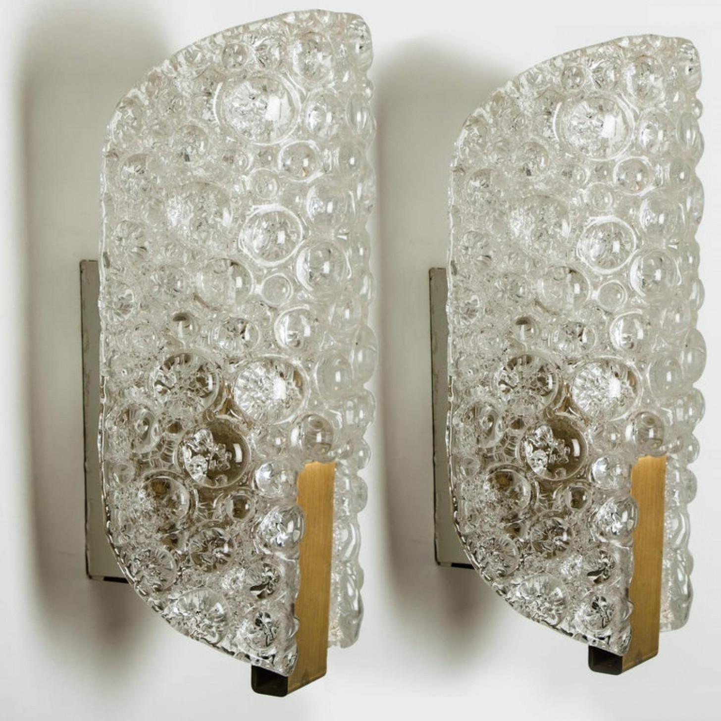 Clean lines to complement all decors. A wonderful high-end Hillebrand wall light fixture with brass detail and thick textured blown glass. The glass plates of the light fixtures are made of tiny glass shards which are molded into the glass during