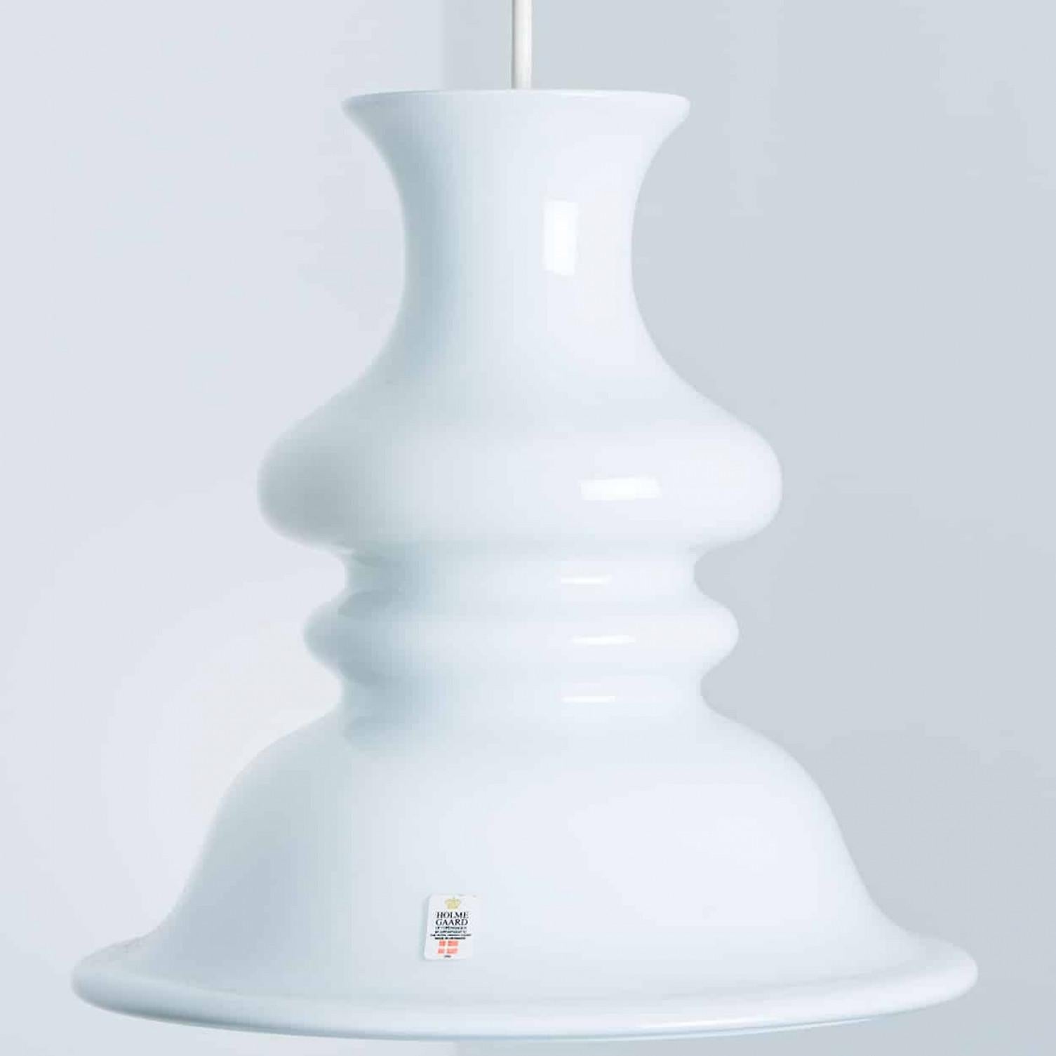 This set of beautiful glass lamps from the Danish brand Holmegaard has a beautiful white color. The design is by Michael Bang, a designer whose work is highly sought after by collectors of the brand today. Beautiful clean and high-end design.

Light